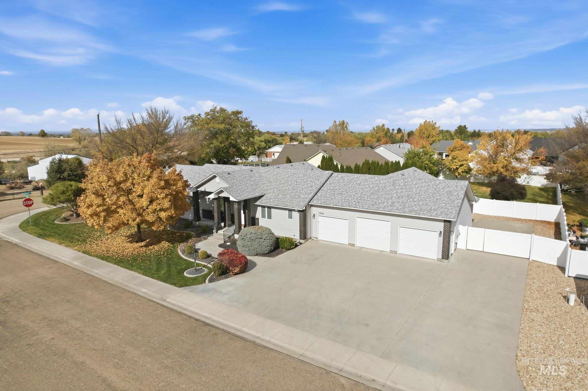 Single story home with driveway, an attached garage, and a shingled roof