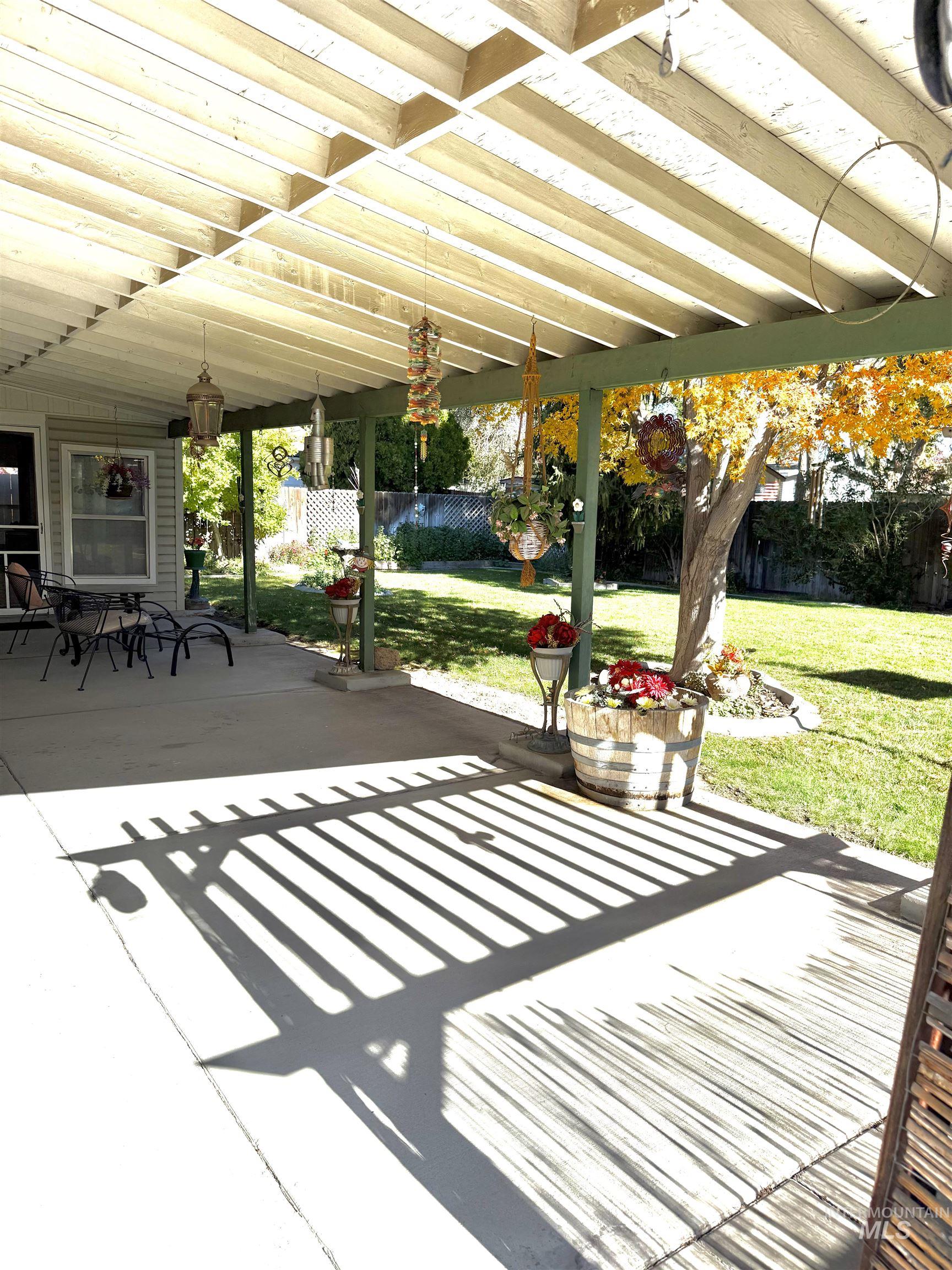 Fenced backyard with a patio