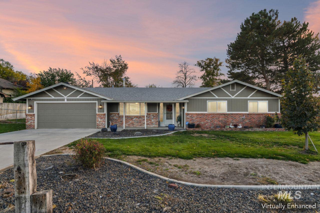 View of front of home with driveway, an attached garage, brick siding, and a porch