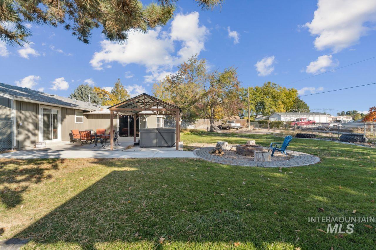 View of yard with a patio area, a hot tub, a gazebo, and an outdoor fire pit