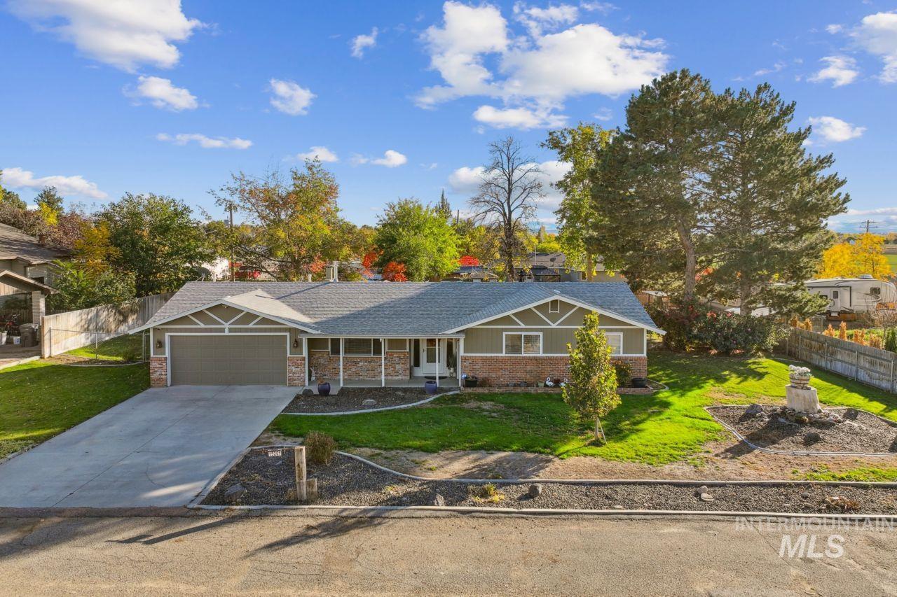View of front of home with concrete driveway, an attached garage, and covered porch