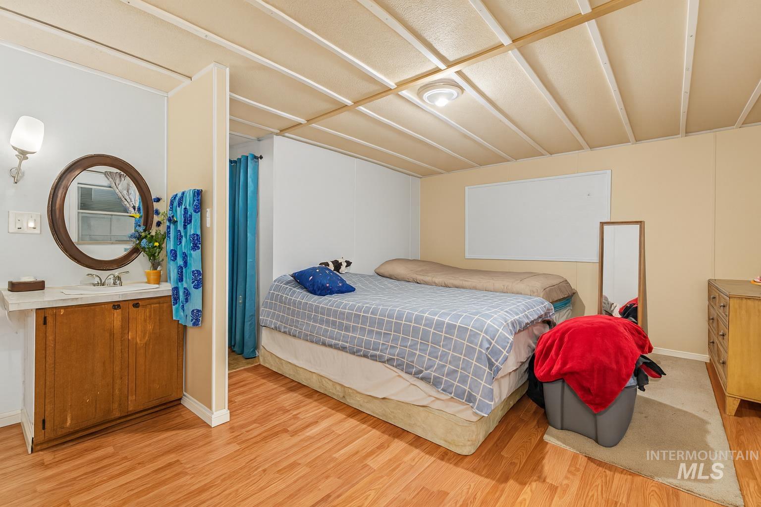 Bedroom with light wood-style floors and a sink