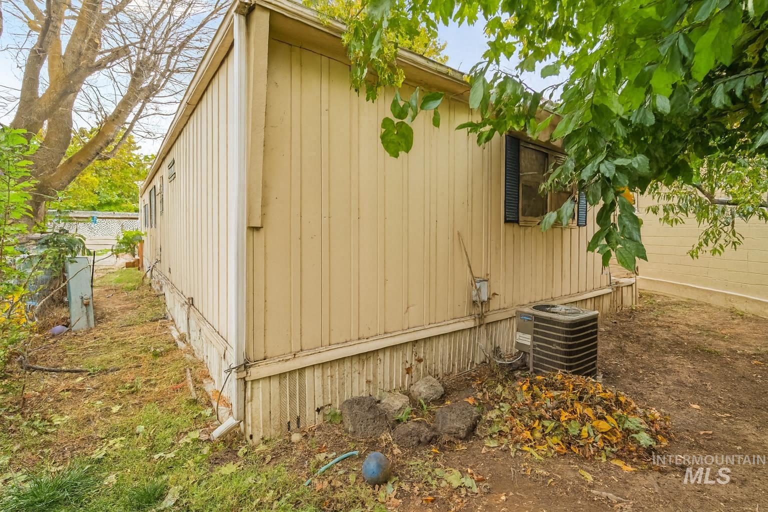 View of side of property with a cooling unit