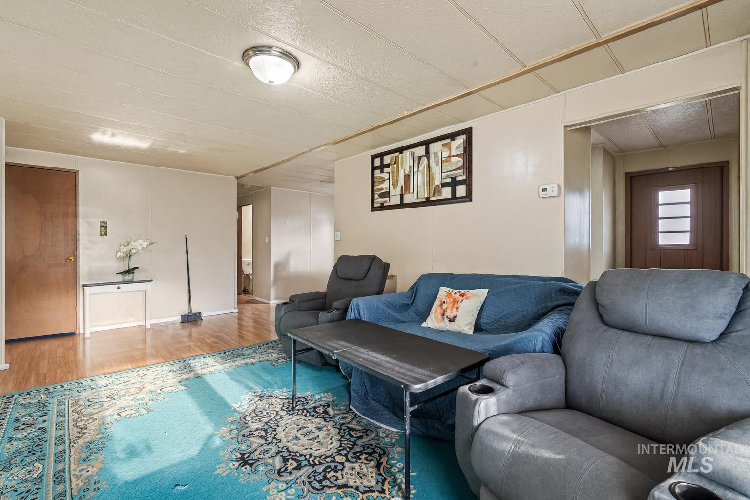 Living room featuring wood finished floors and baseboards