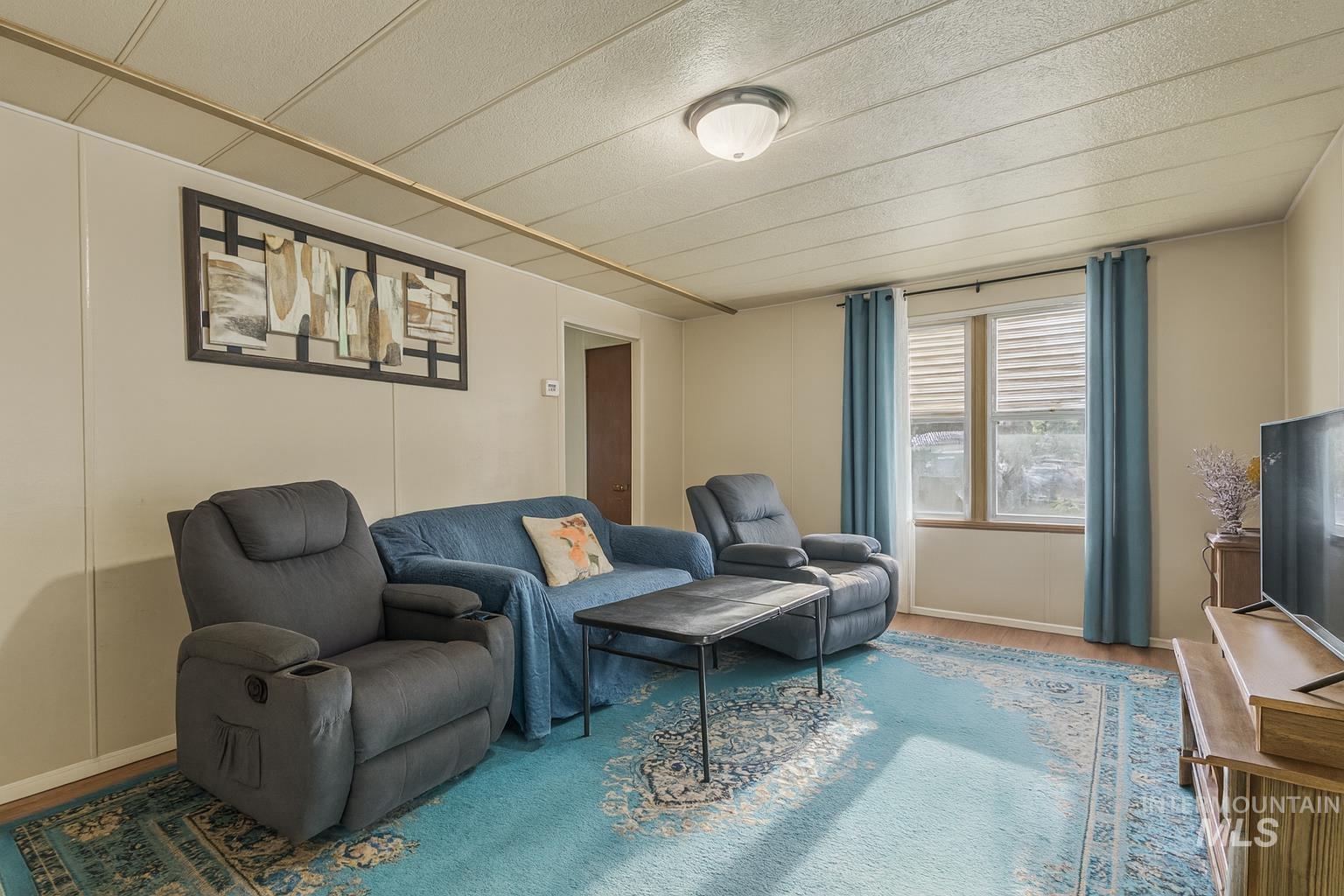 Living room featuring wood finished floors and baseboards