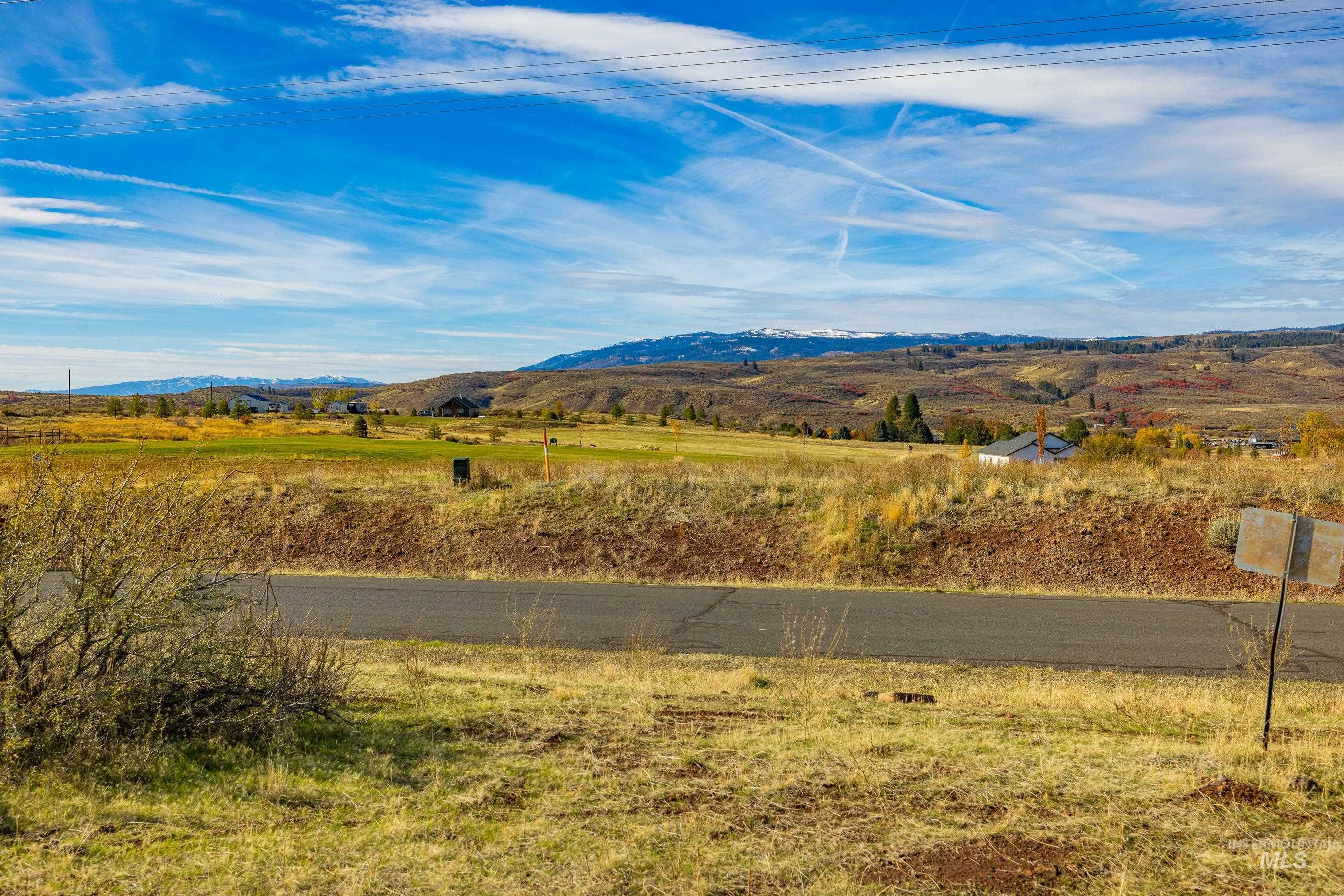 View of mountain backdrop with rural landscape