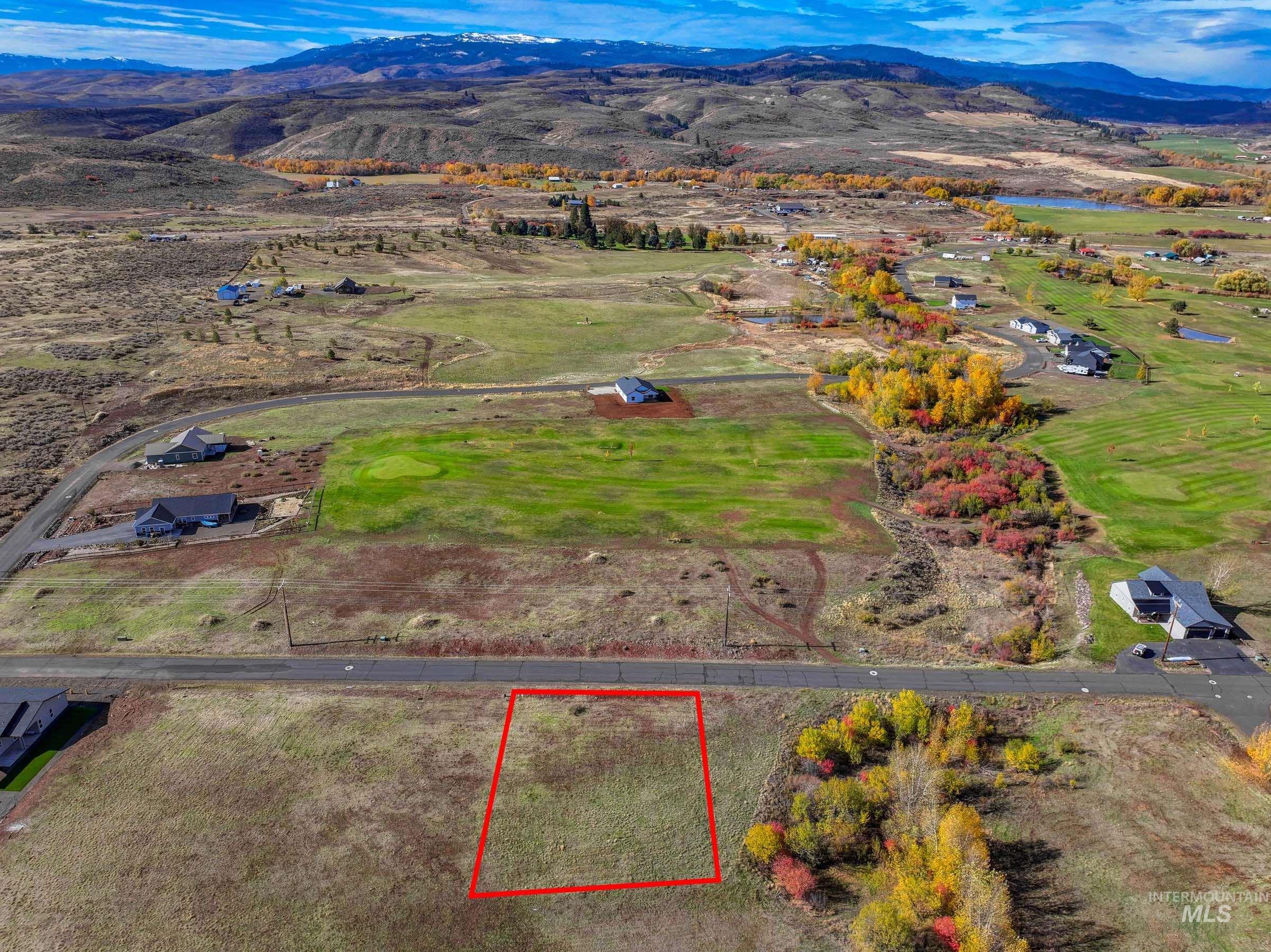 Aerial view of property's location featuring mountains and property parcel outlined