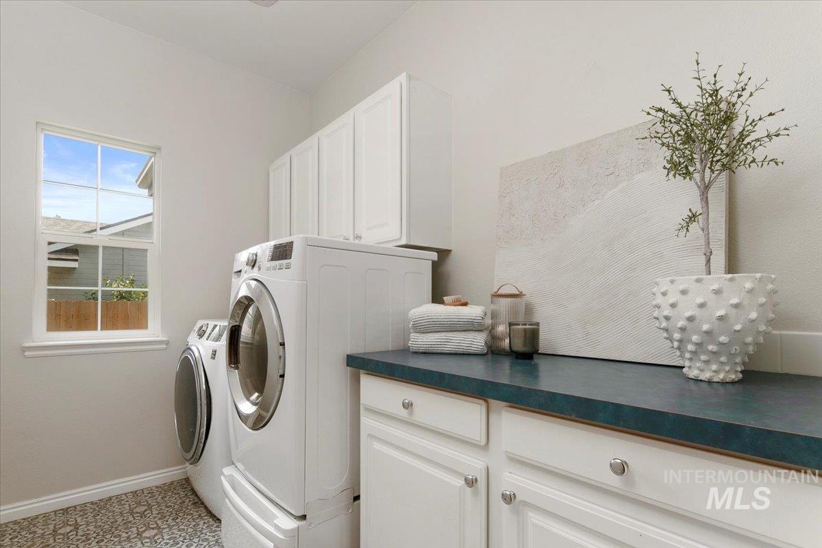 Laundry area featuring cabinet space and washer and dryer