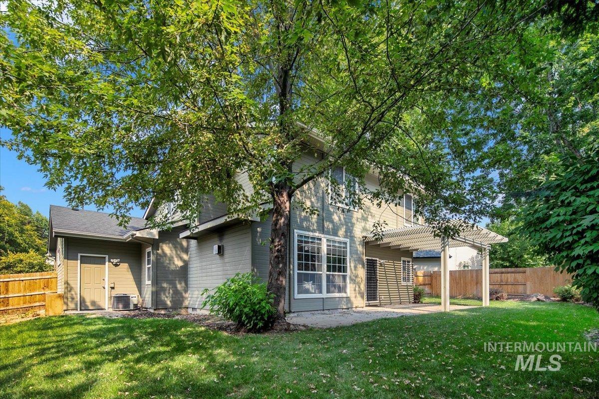 Back of property with a fenced backyard, a patio, and a pergola
