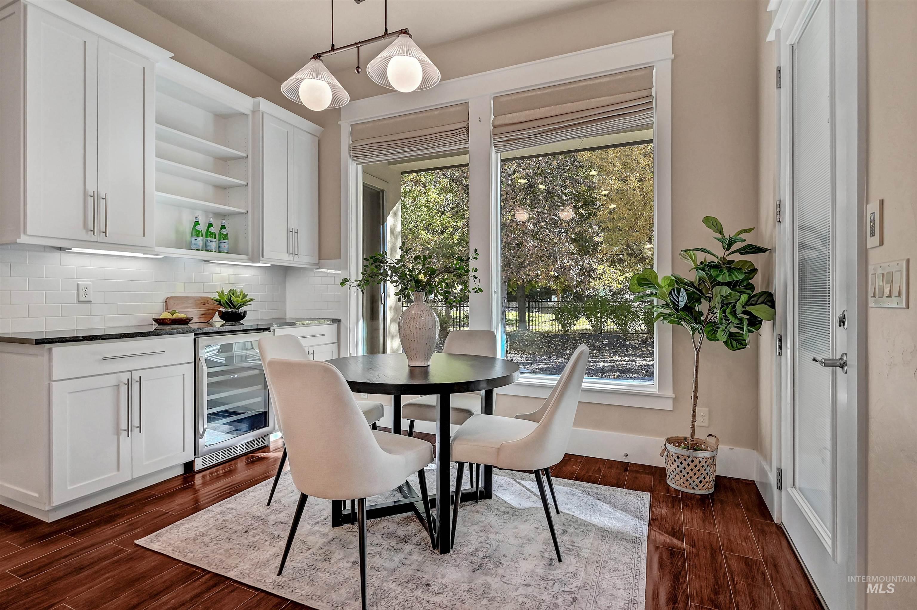 Dining area featuring dark wood finished floors and beverage cooler