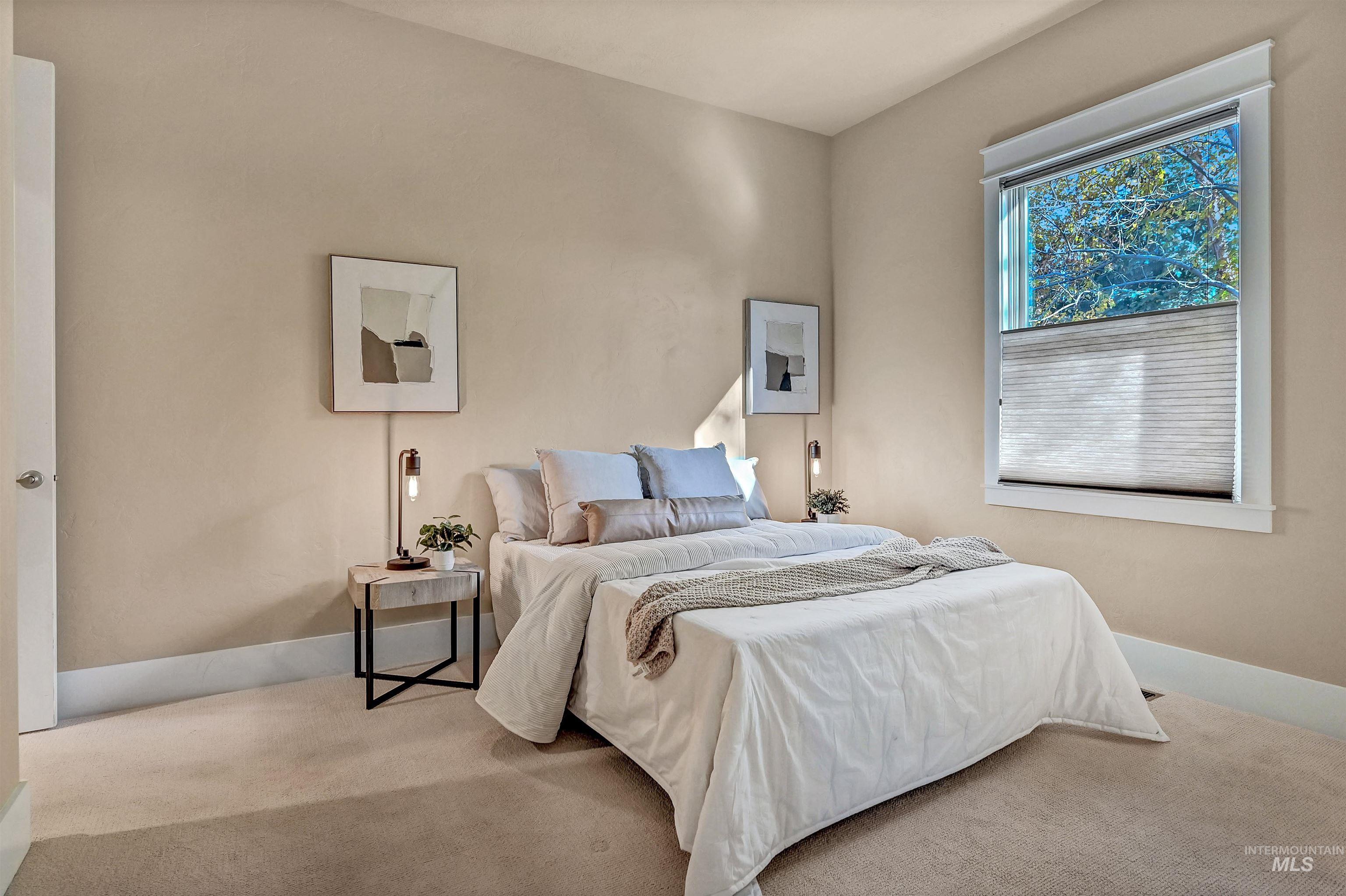 Carpeted bedroom with baseboards