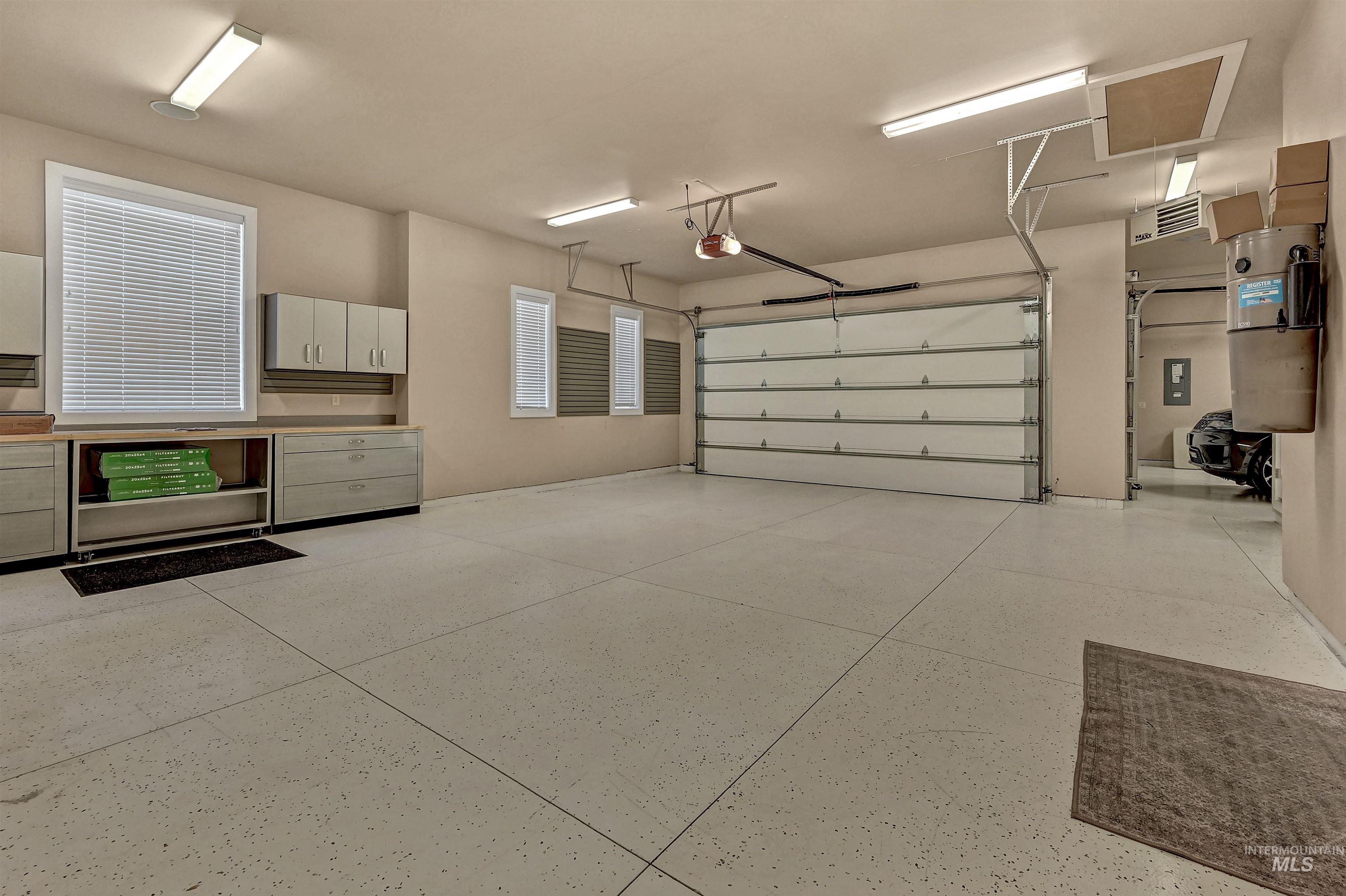 Garage featuring a central vacuum unit and electric panel