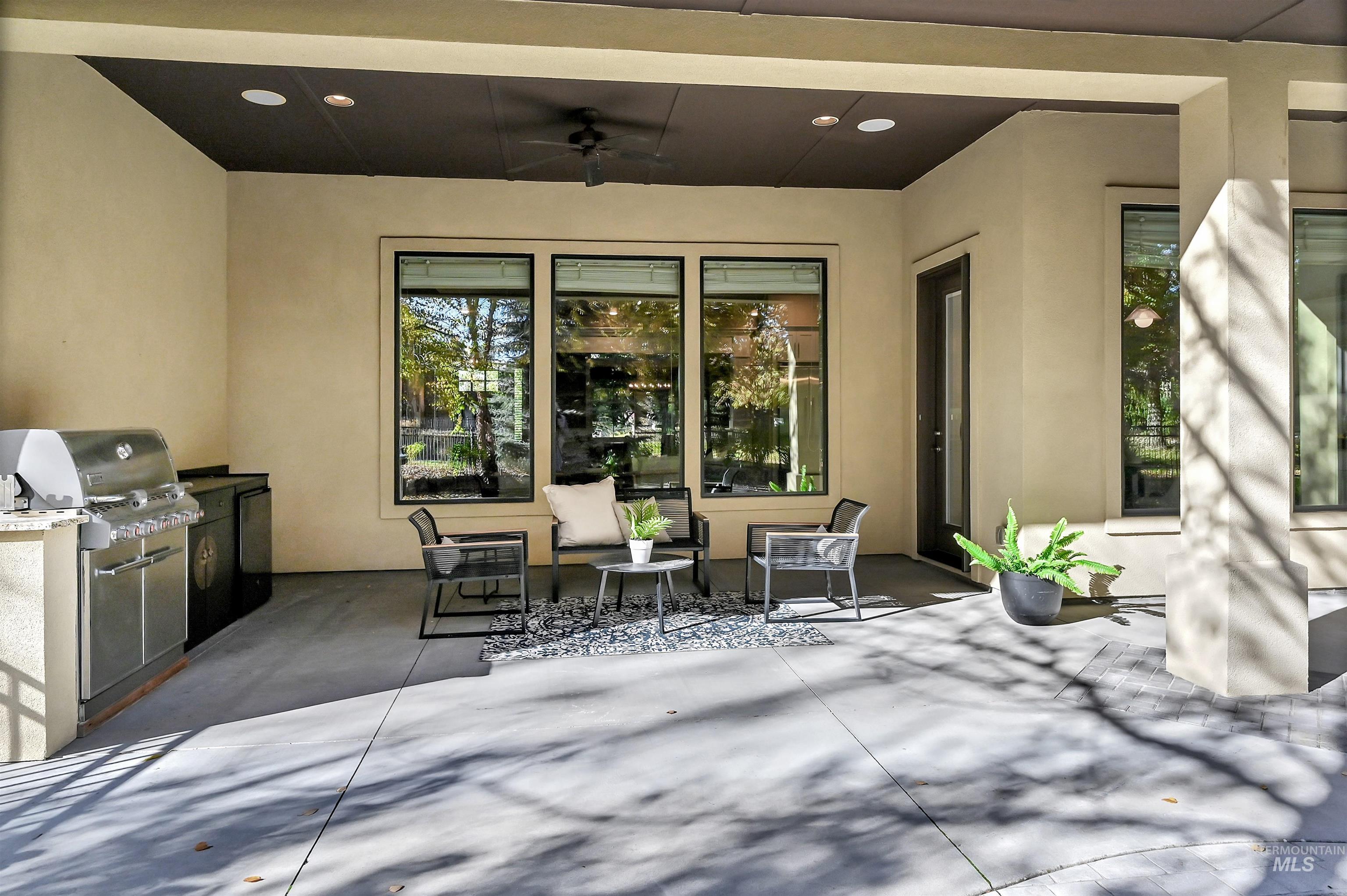 View of patio featuring a ceiling fan and an outdoor kitchen