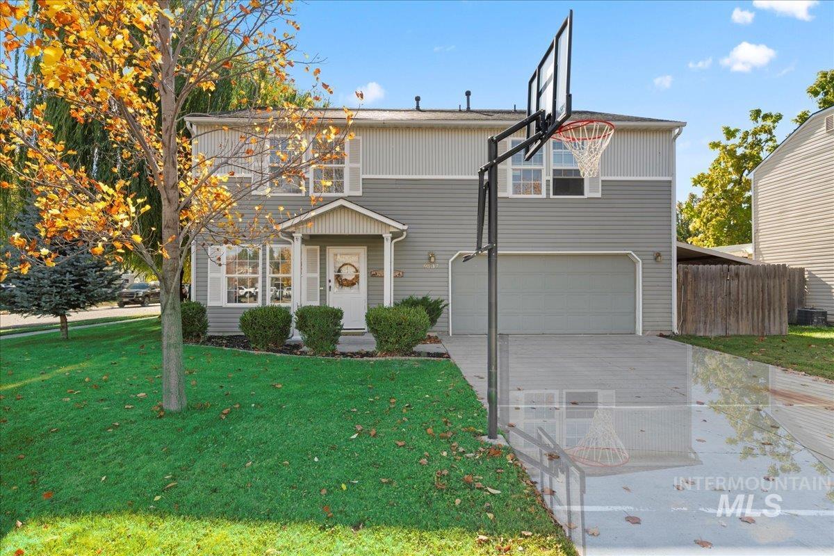 Traditional-style home featuring driveway and a garage