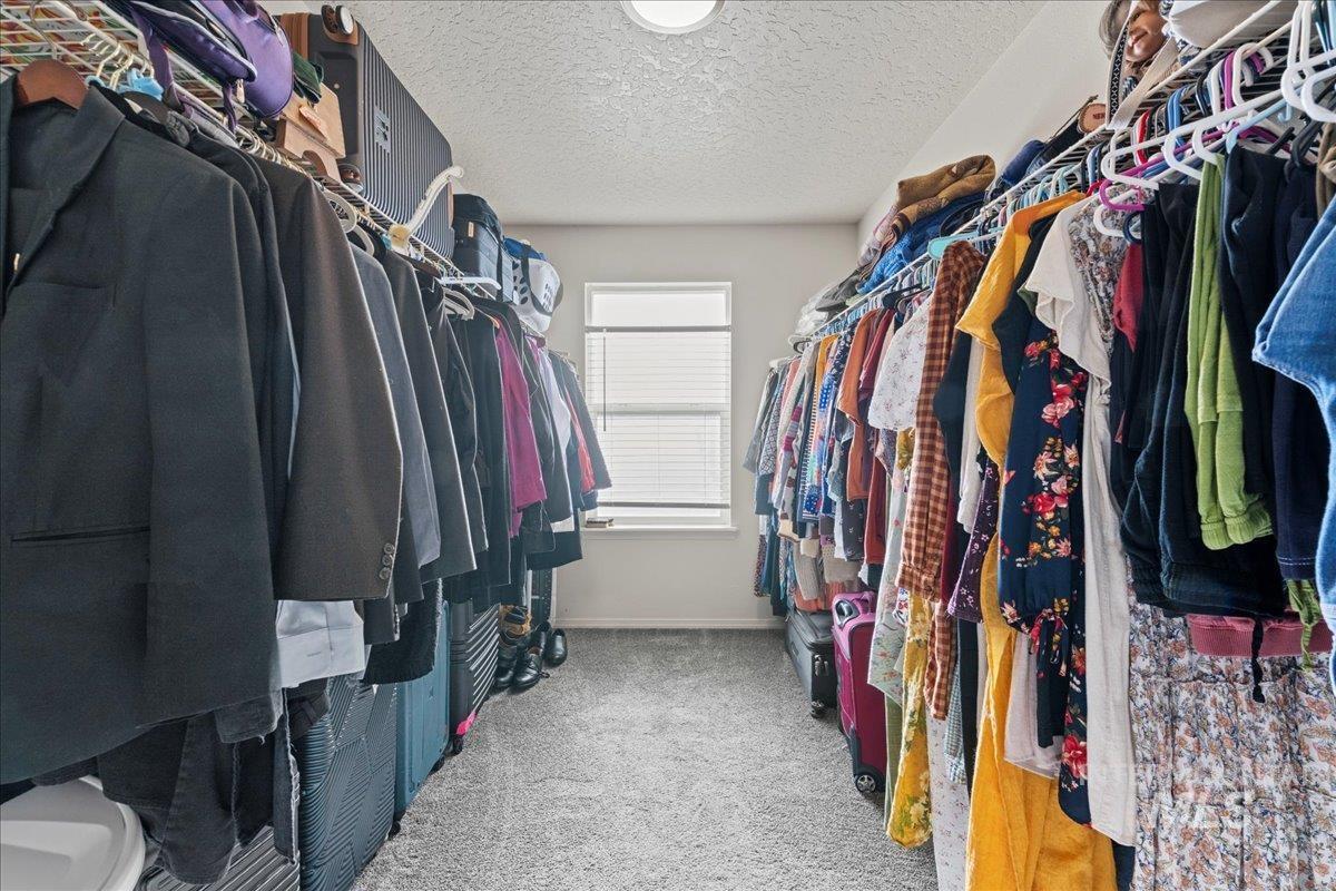 Walk in closet with light carpet