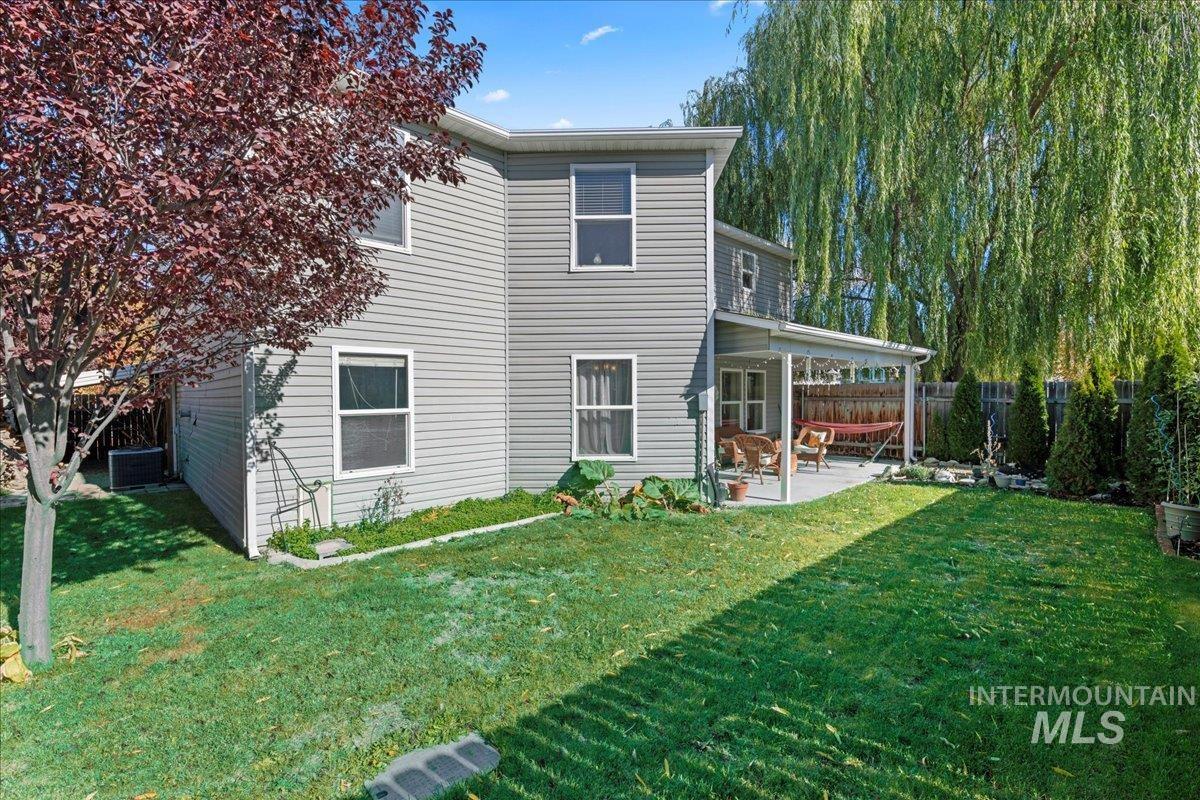 Rear view of house featuring a patio and a fenced backyard