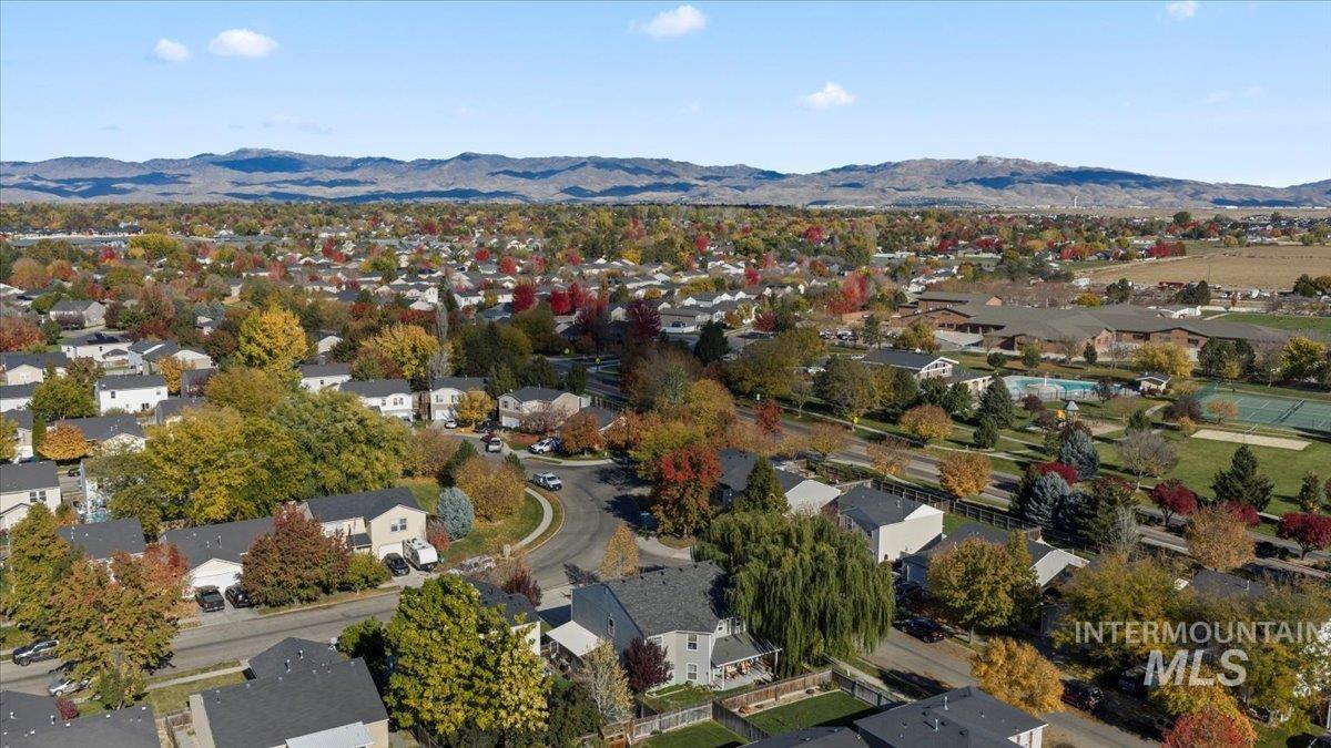 Aerial perspective of suburban area featuring a mountainous background