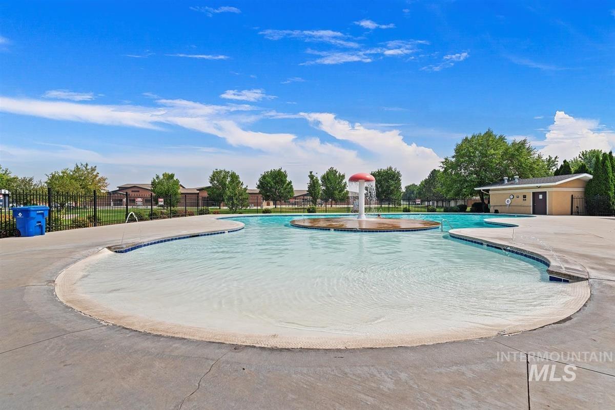 Community pool with a patio