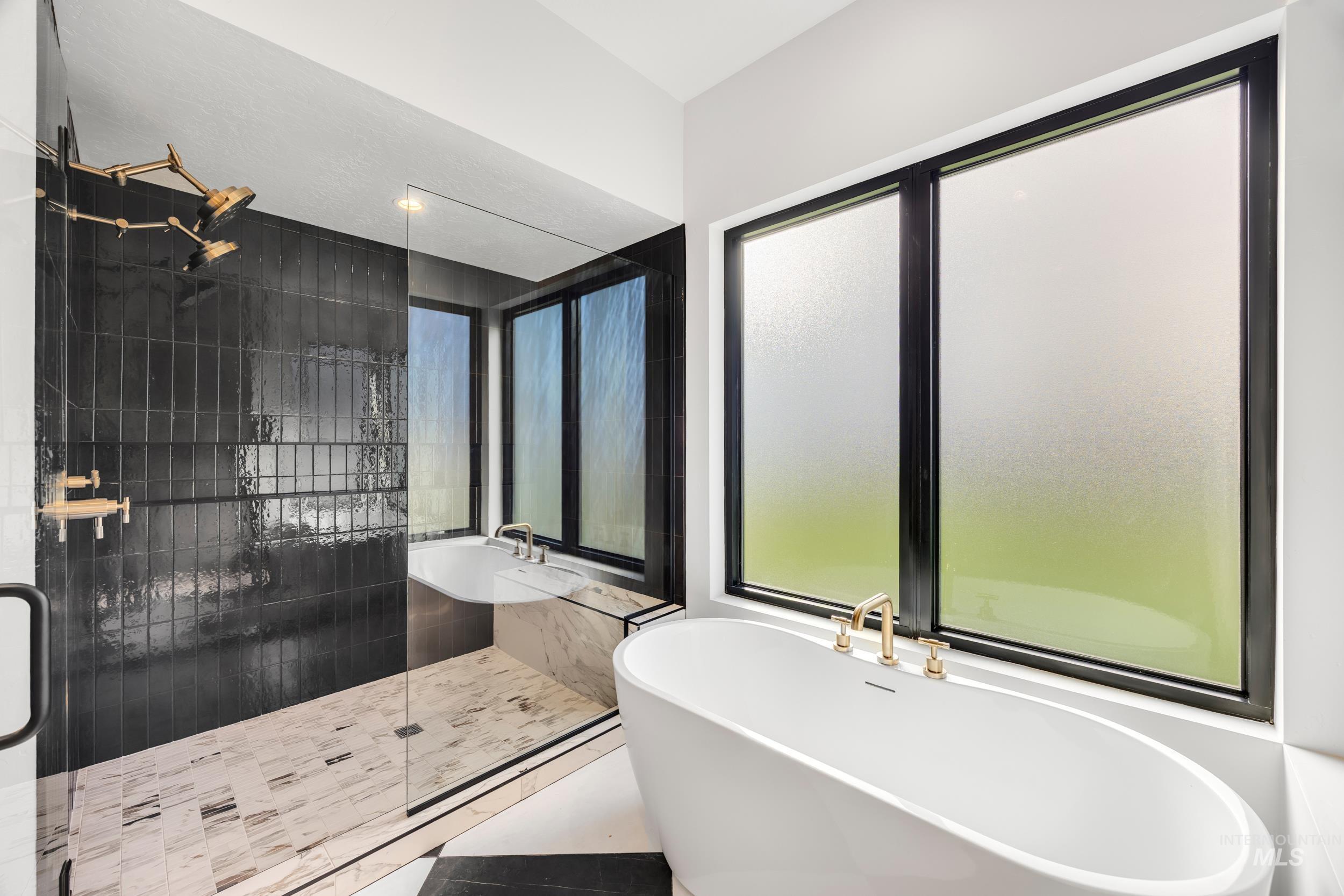 Full bath with a soaking tub and a shower stall