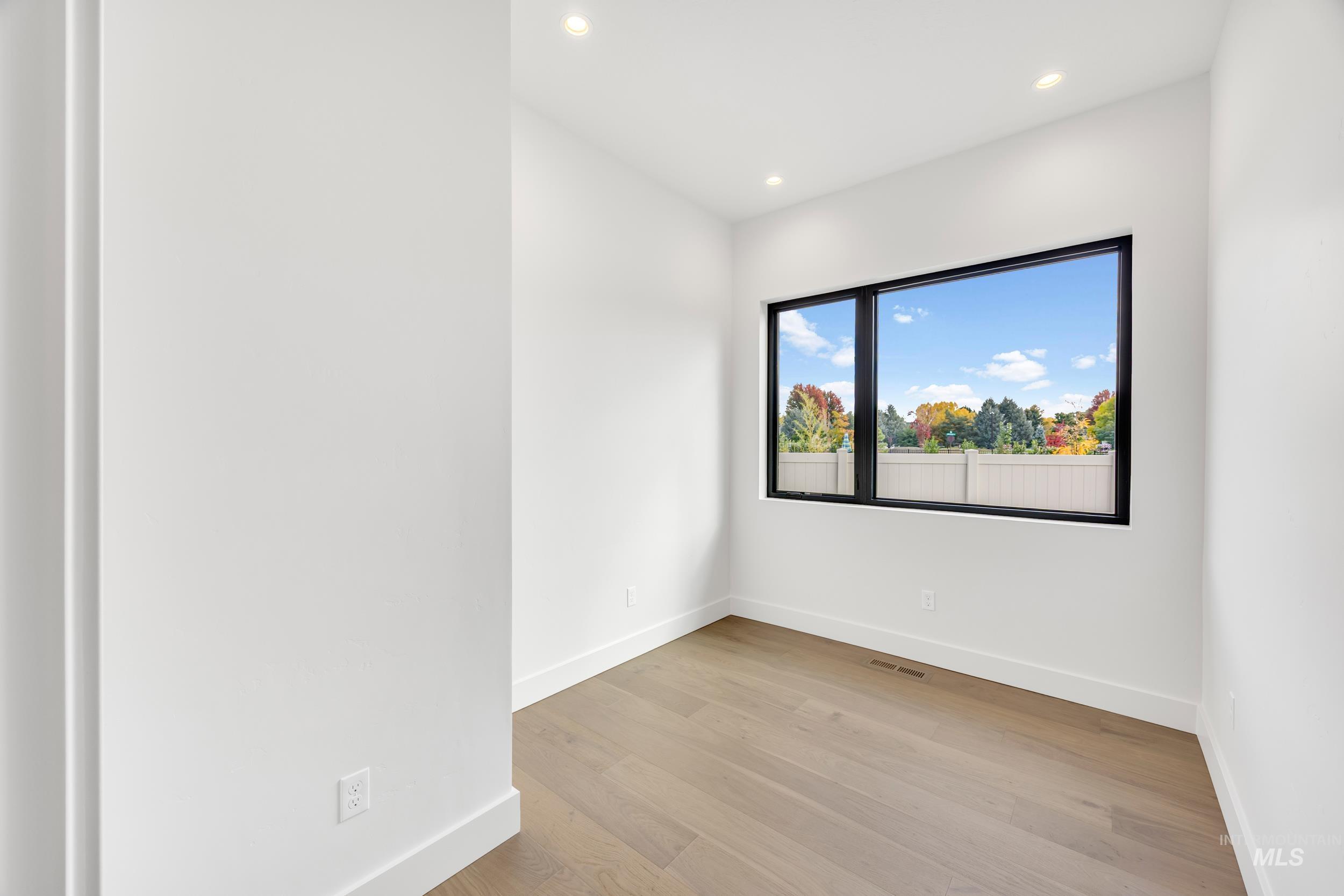 Unfurnished room featuring light wood-style floors and recessed lighting
