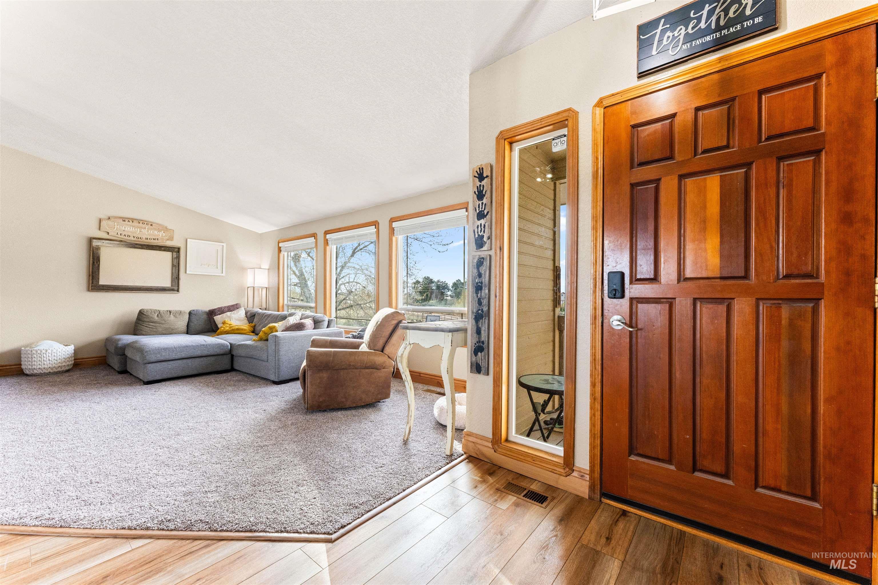 Entryway with lofted ceiling and wood finished floors