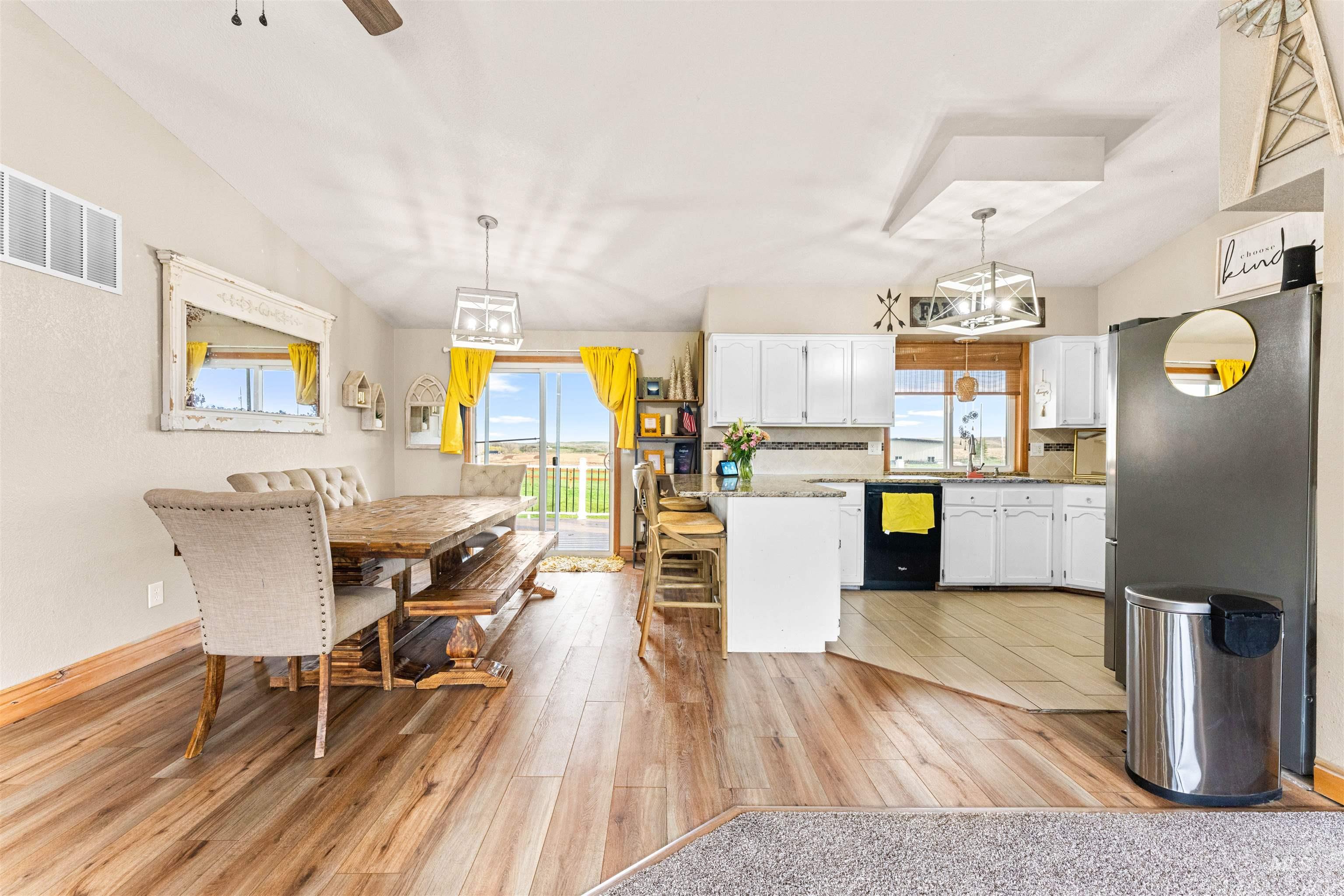 Dining space featuring a chandelier, light wood-style flooring, and ceiling fan