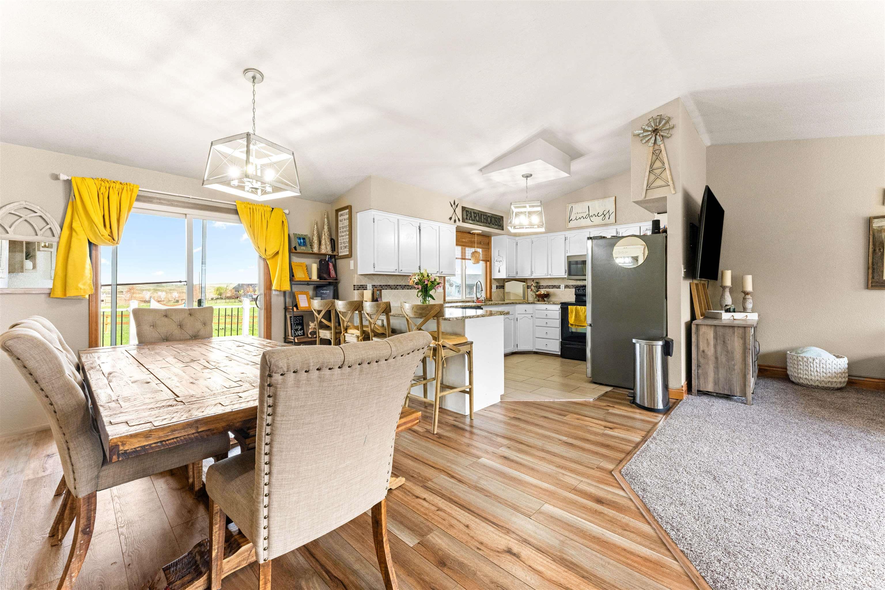 Dining area featuring light wood-type flooring and a chandelier