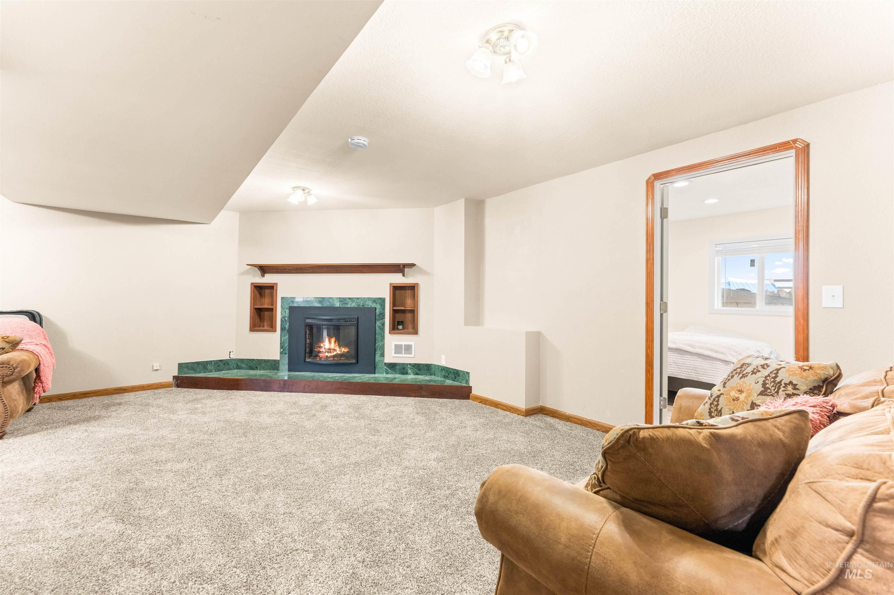 Living area featuring carpet floors and a fireplace
