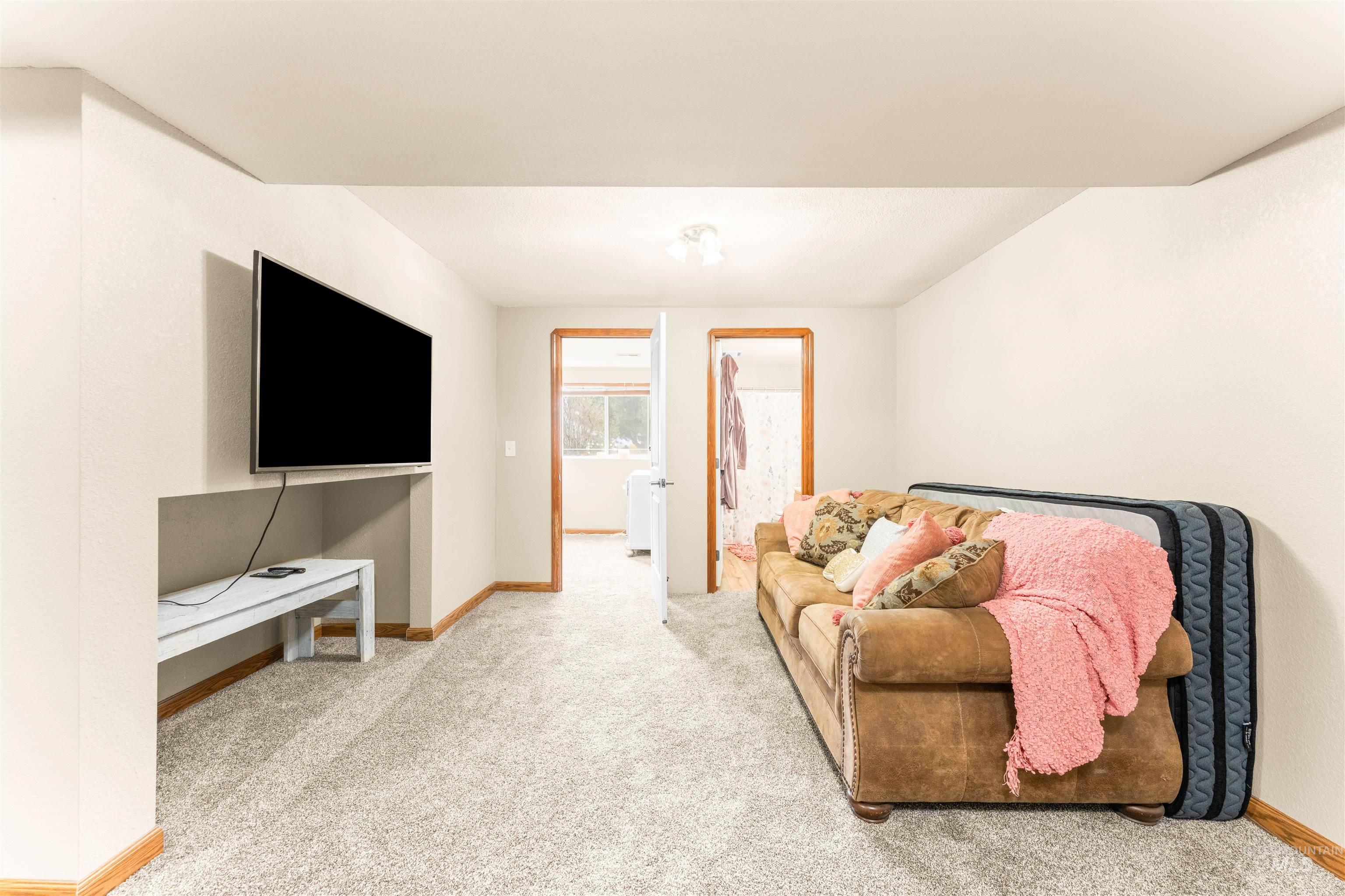 Living room with light colored carpet and baseboards