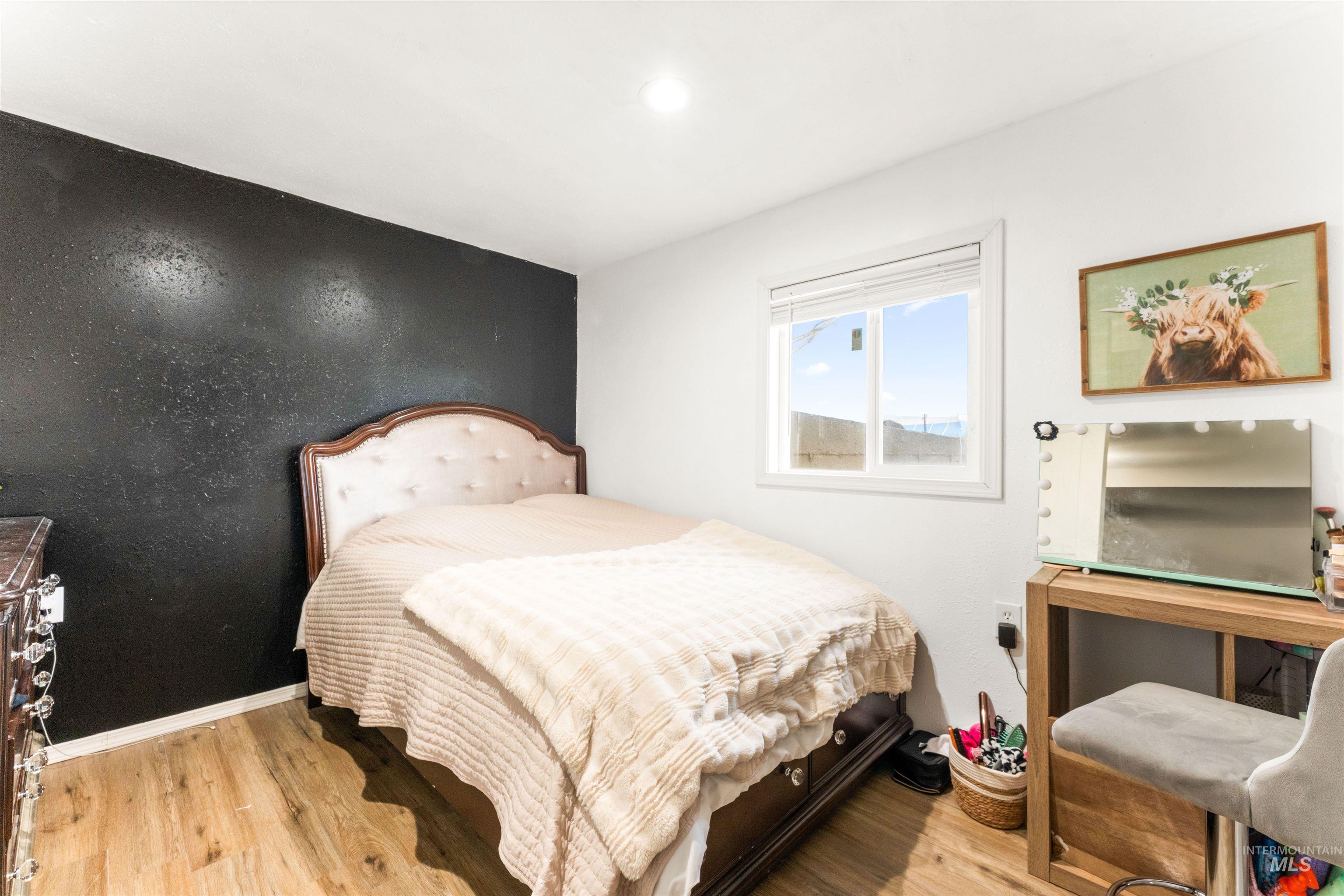 Bedroom featuring light wood-style floors and baseboards