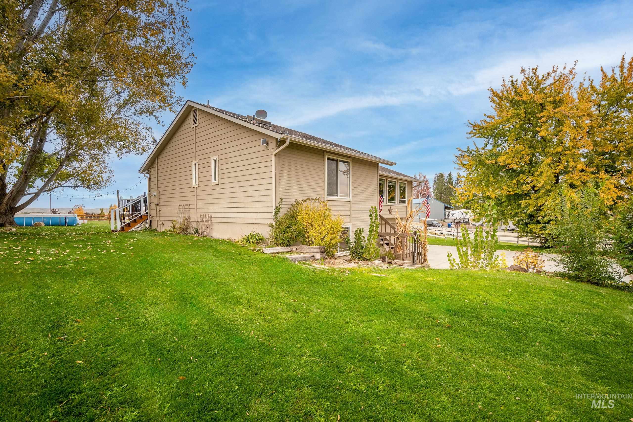 View of side of home with a lawn and stairway