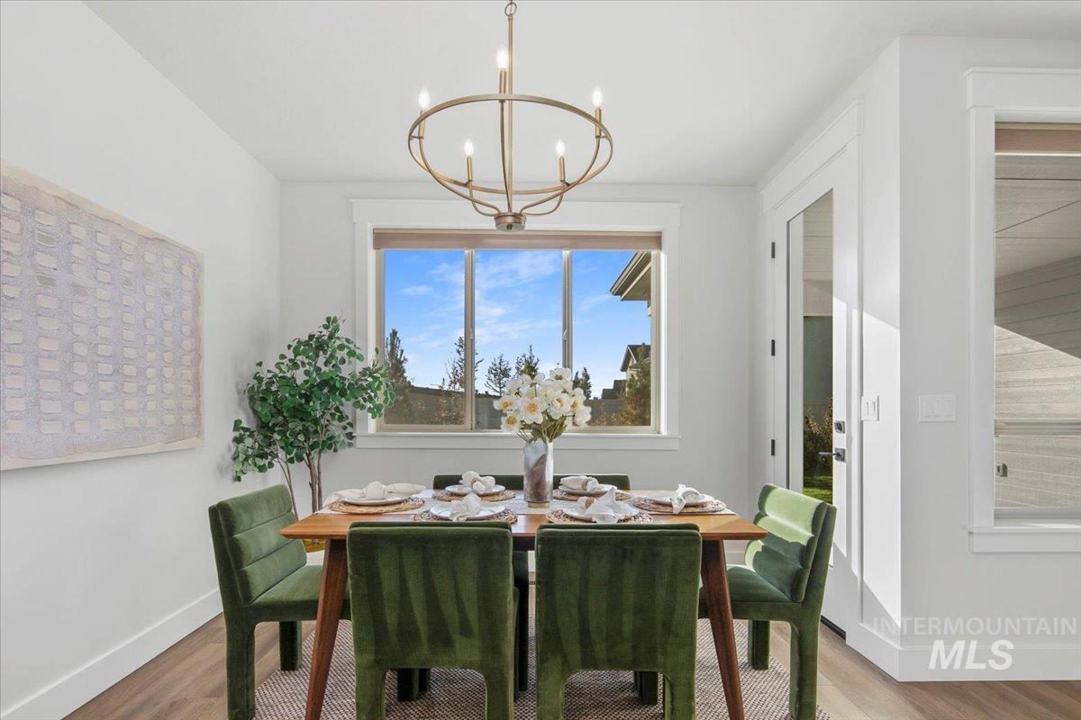 Dining area with a chandelier and wood finished floors