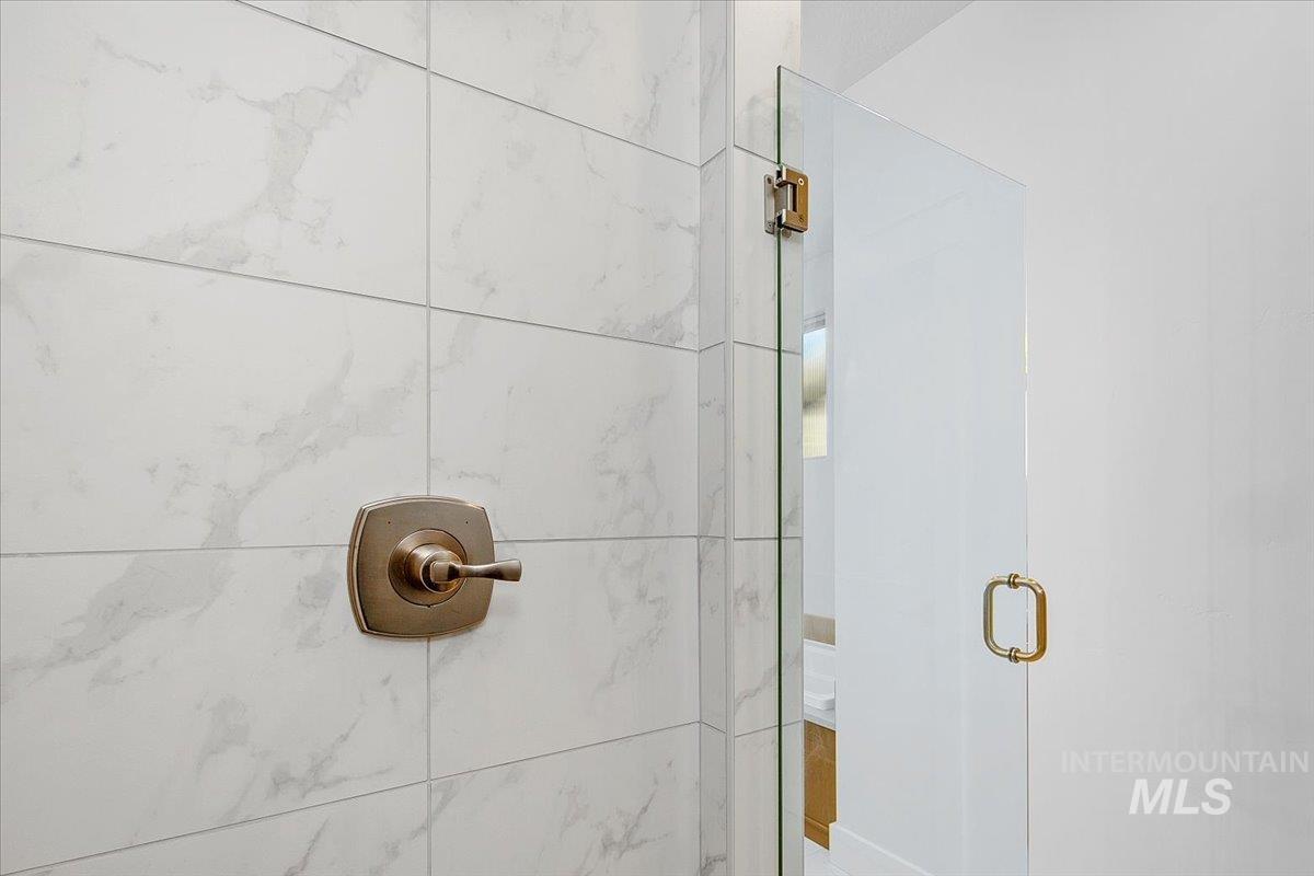 Bathroom view of a marble finish shower