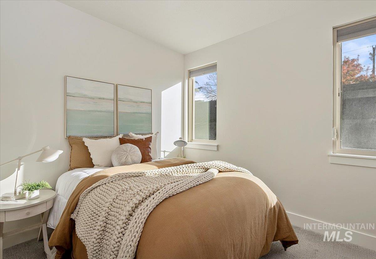 Bedroom featuring baseboards and carpet floors