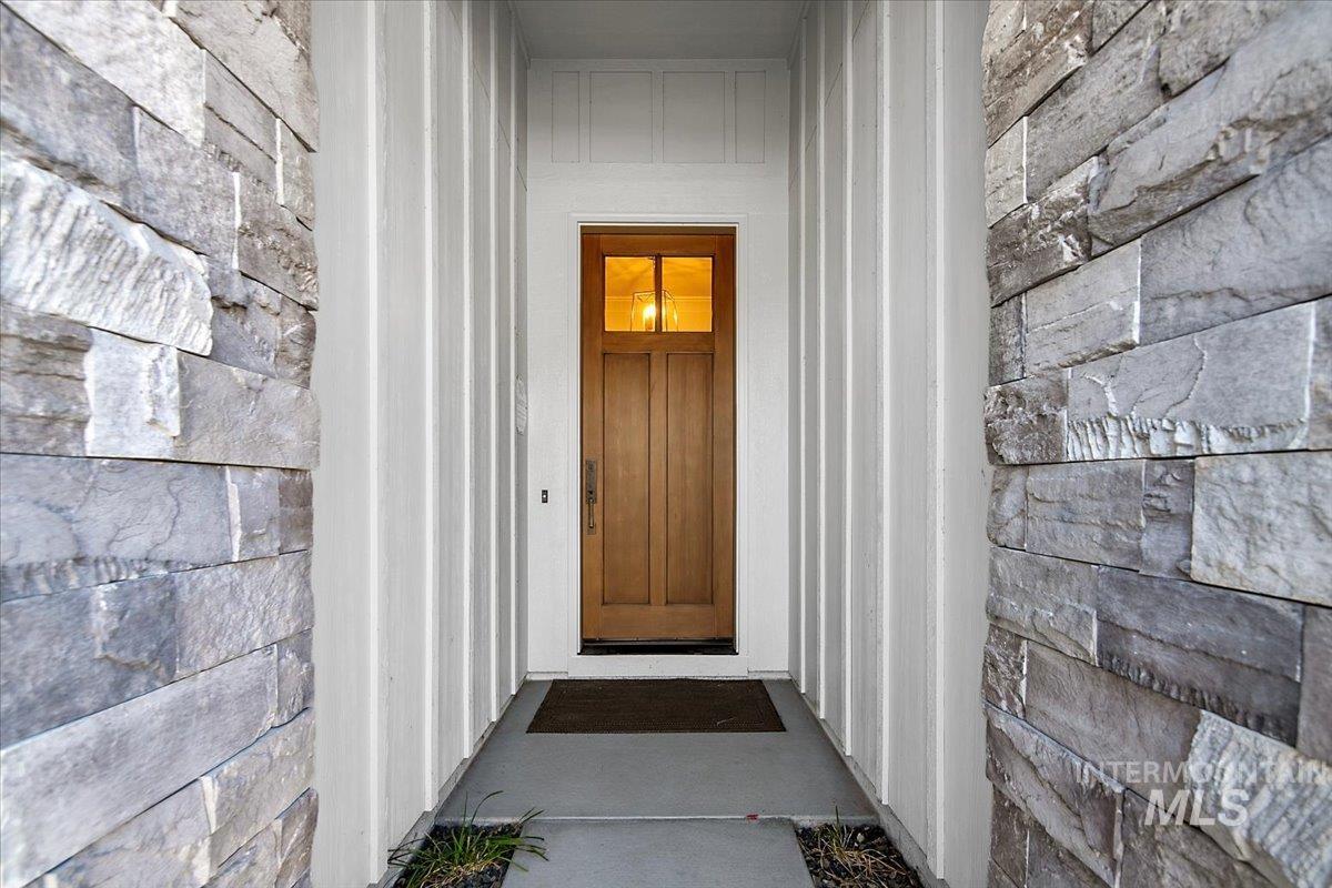 View of exterior entry featuring stone siding
