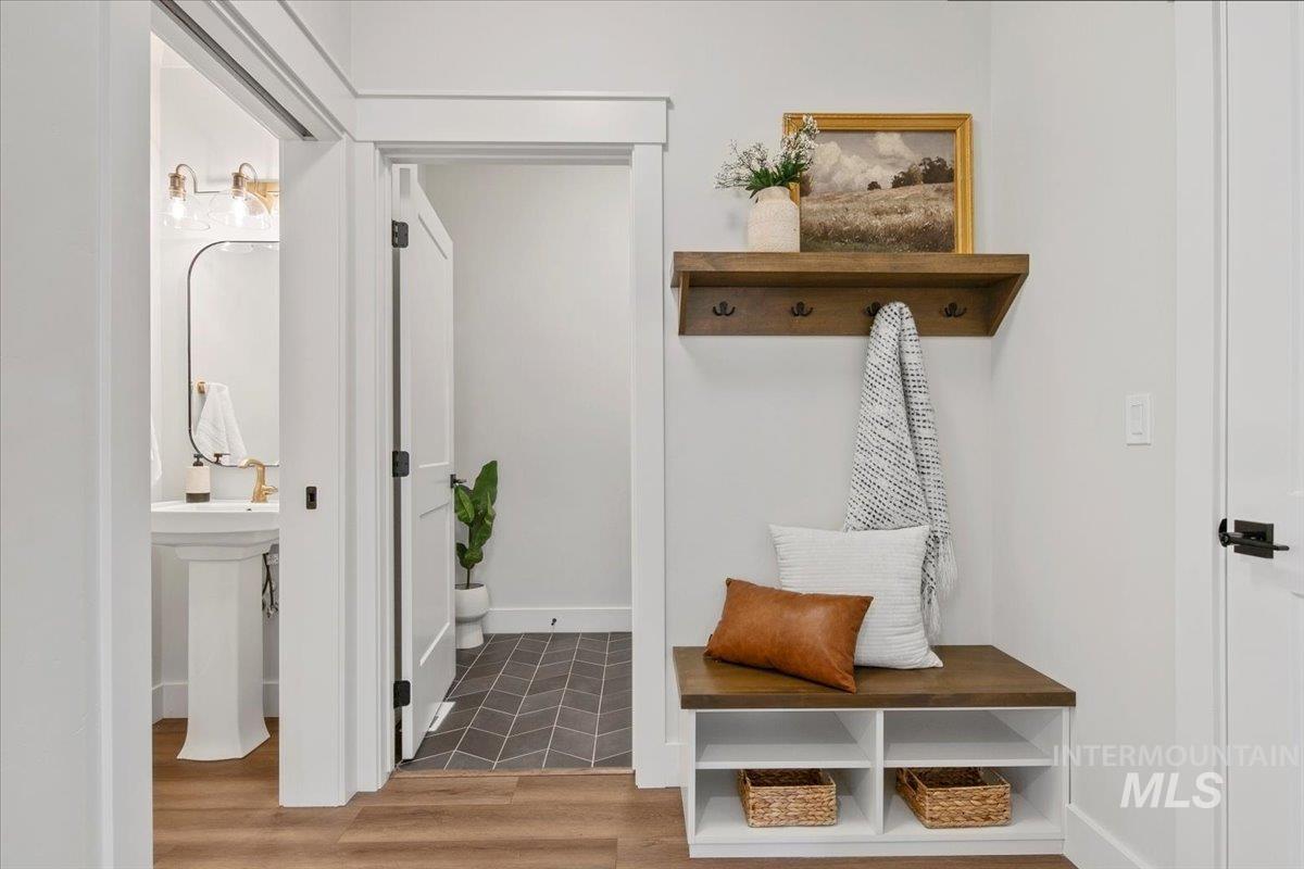 Mudroom featuring baseboards and light wood-style floors