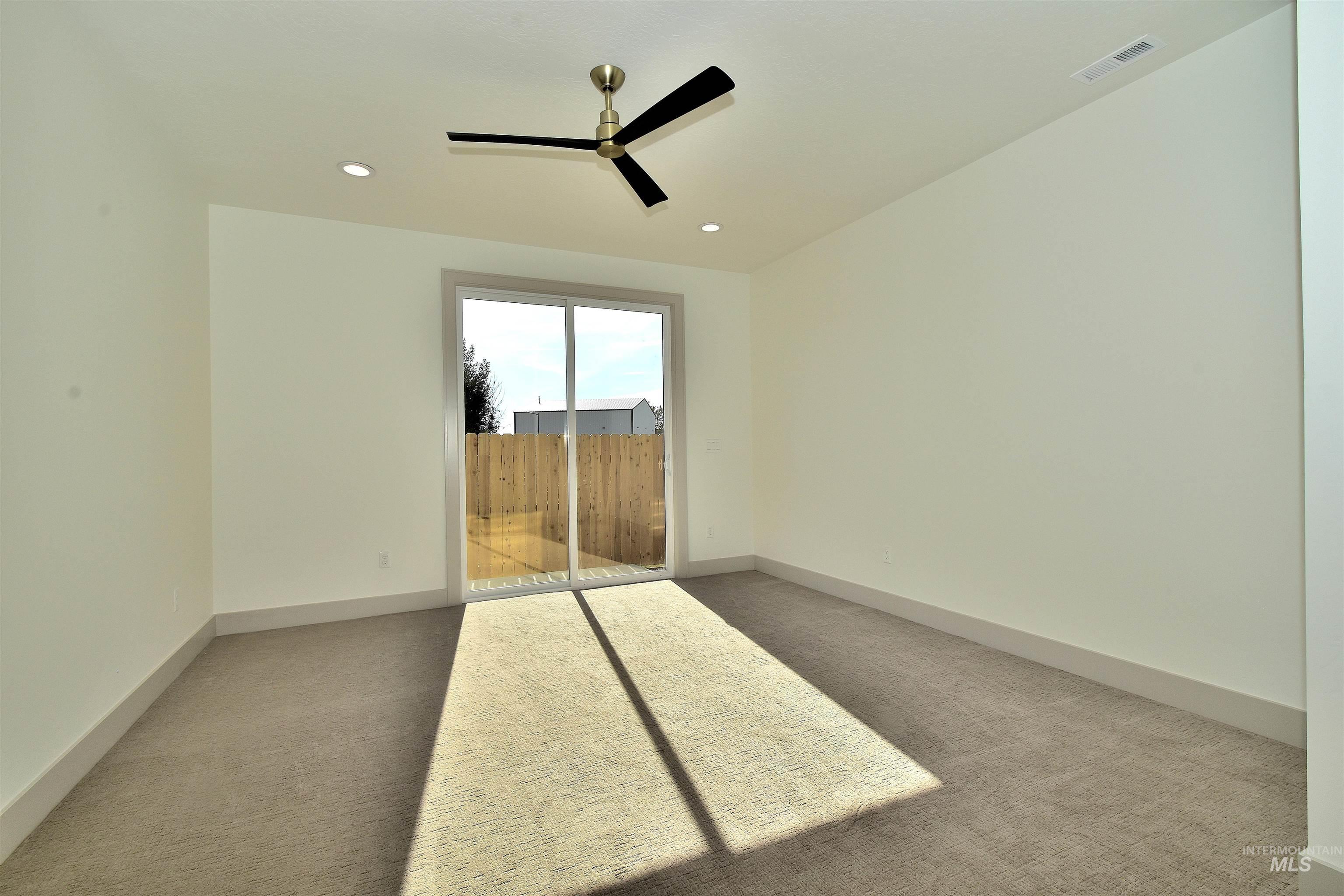 Unfurnished bedroom featuring light colored carpet, access to outside, recessed lighting, and a ceiling fan