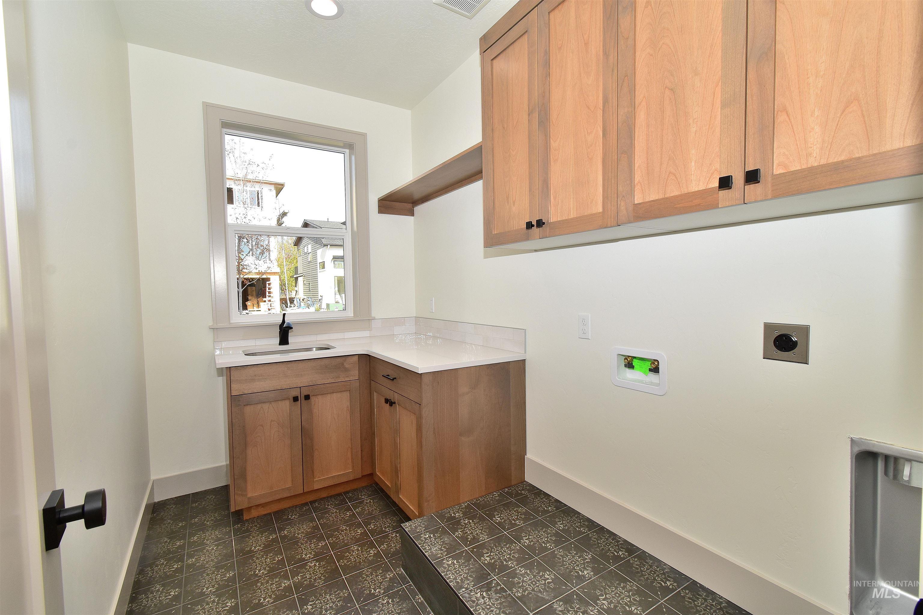 Washroom featuring washer hookup, hookup for an electric dryer, cabinet space, and recessed lighting