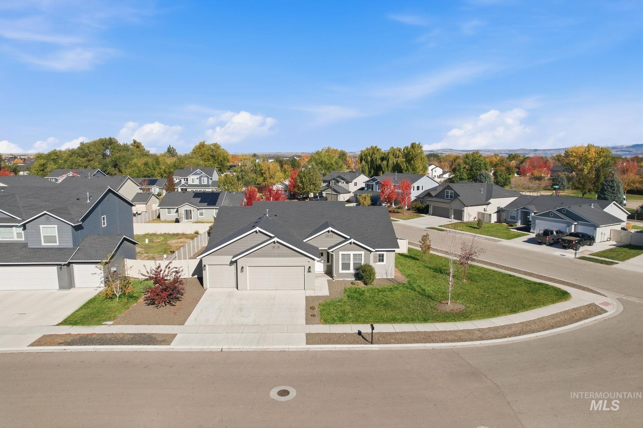 View of front facade with driveway, a residential view, and a garage