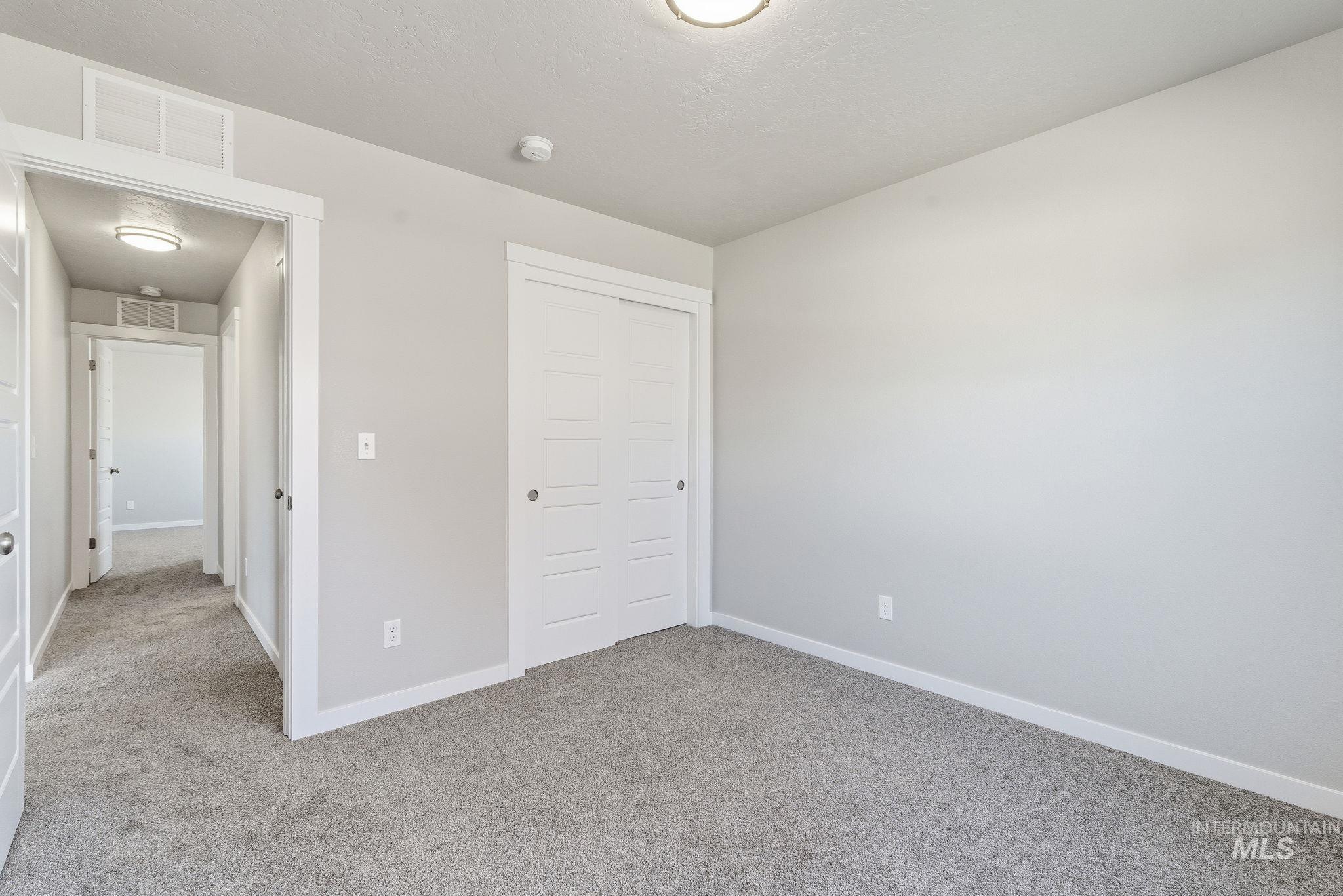 Unfurnished bedroom featuring carpet floors and a closet