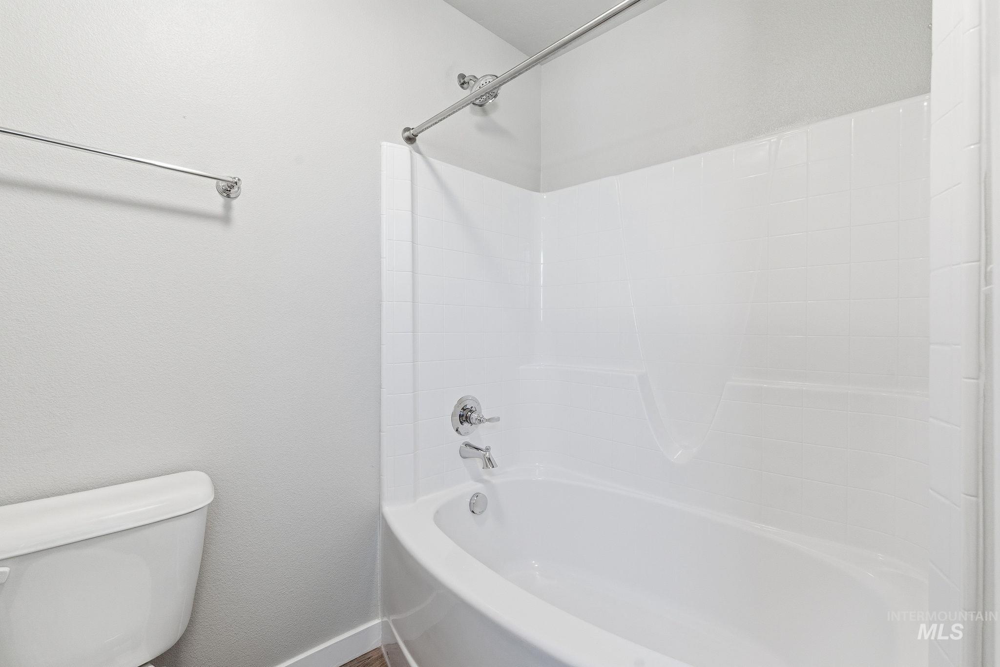 Bathroom with washtub / shower combination and toilet