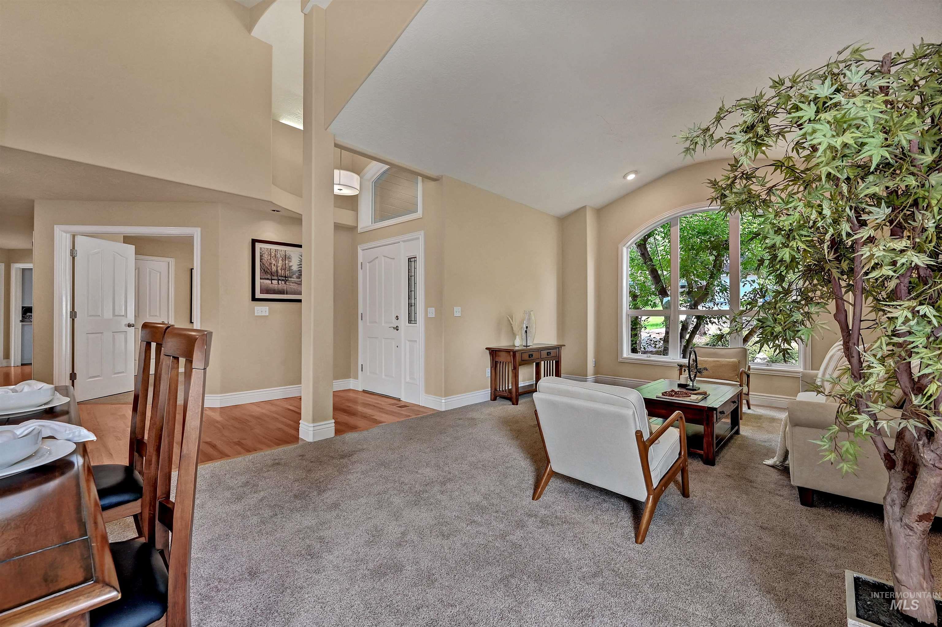 Living room featuring vaulted ceiling and carpet