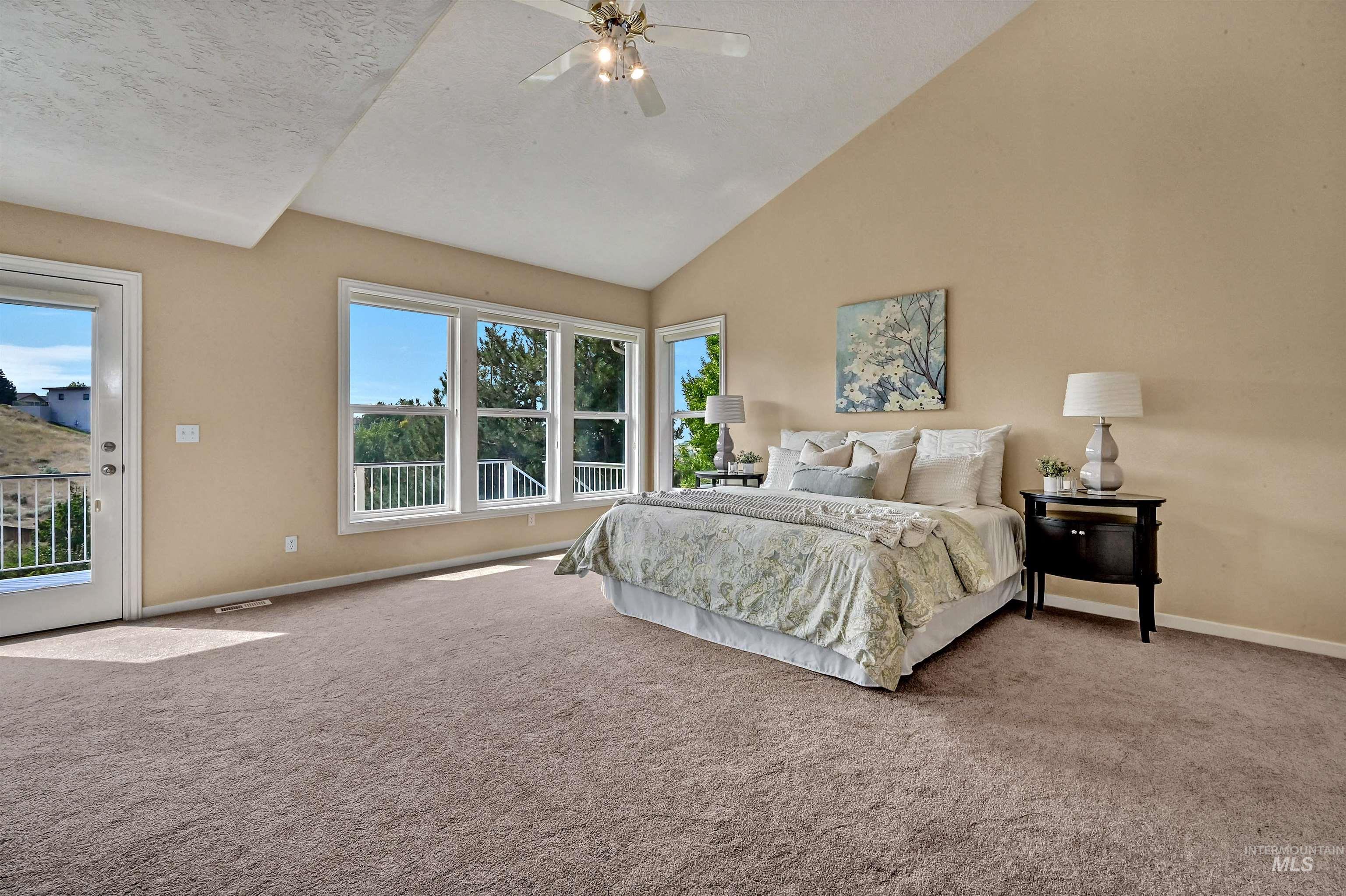 Bedroom featuring carpet, high vaulted ceiling, access to exterior, a ceiling fan, and a textured ceiling