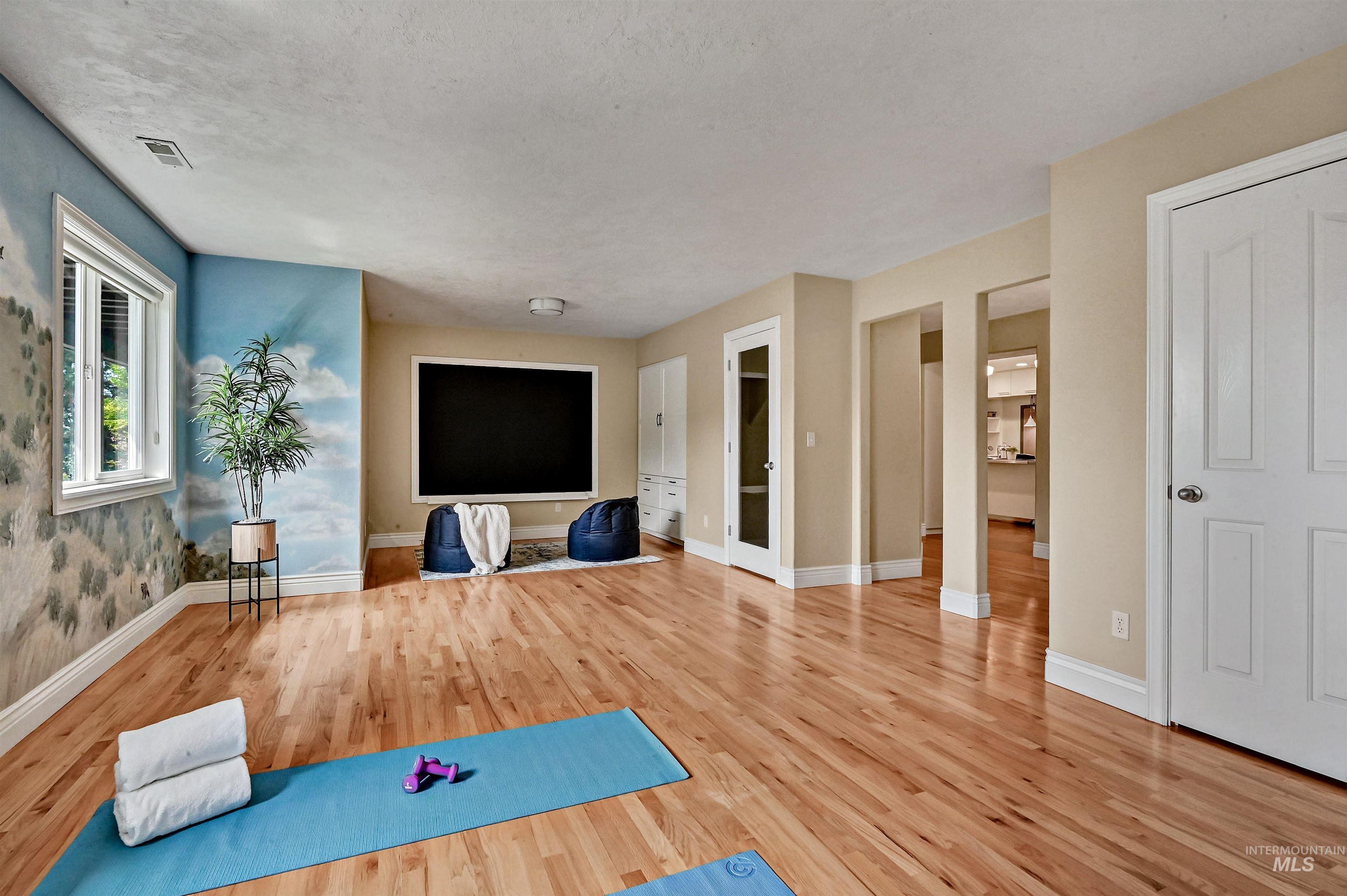 Workout area featuring wood finished floors and a textured ceiling