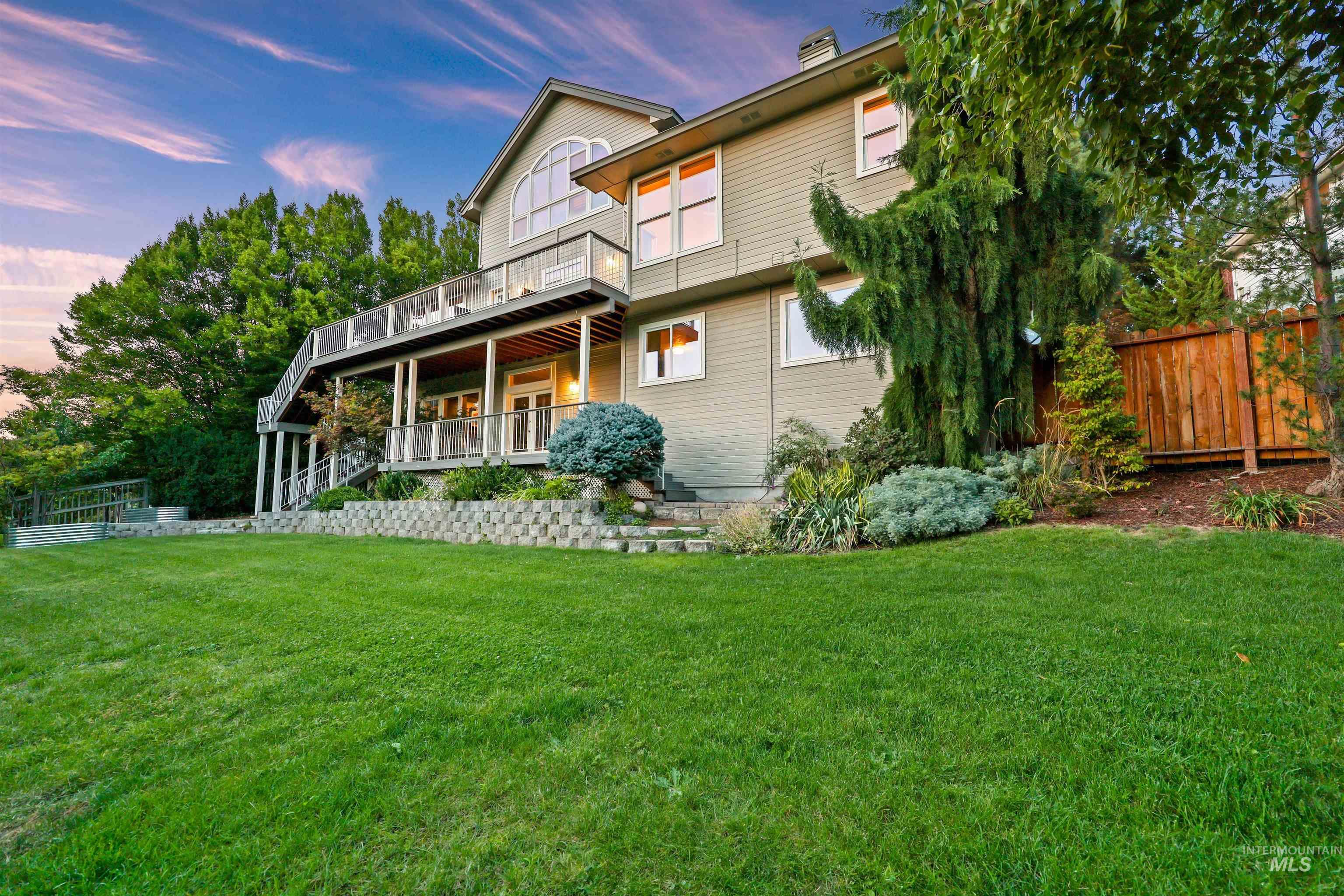 Back of house at dusk featuring covered porch