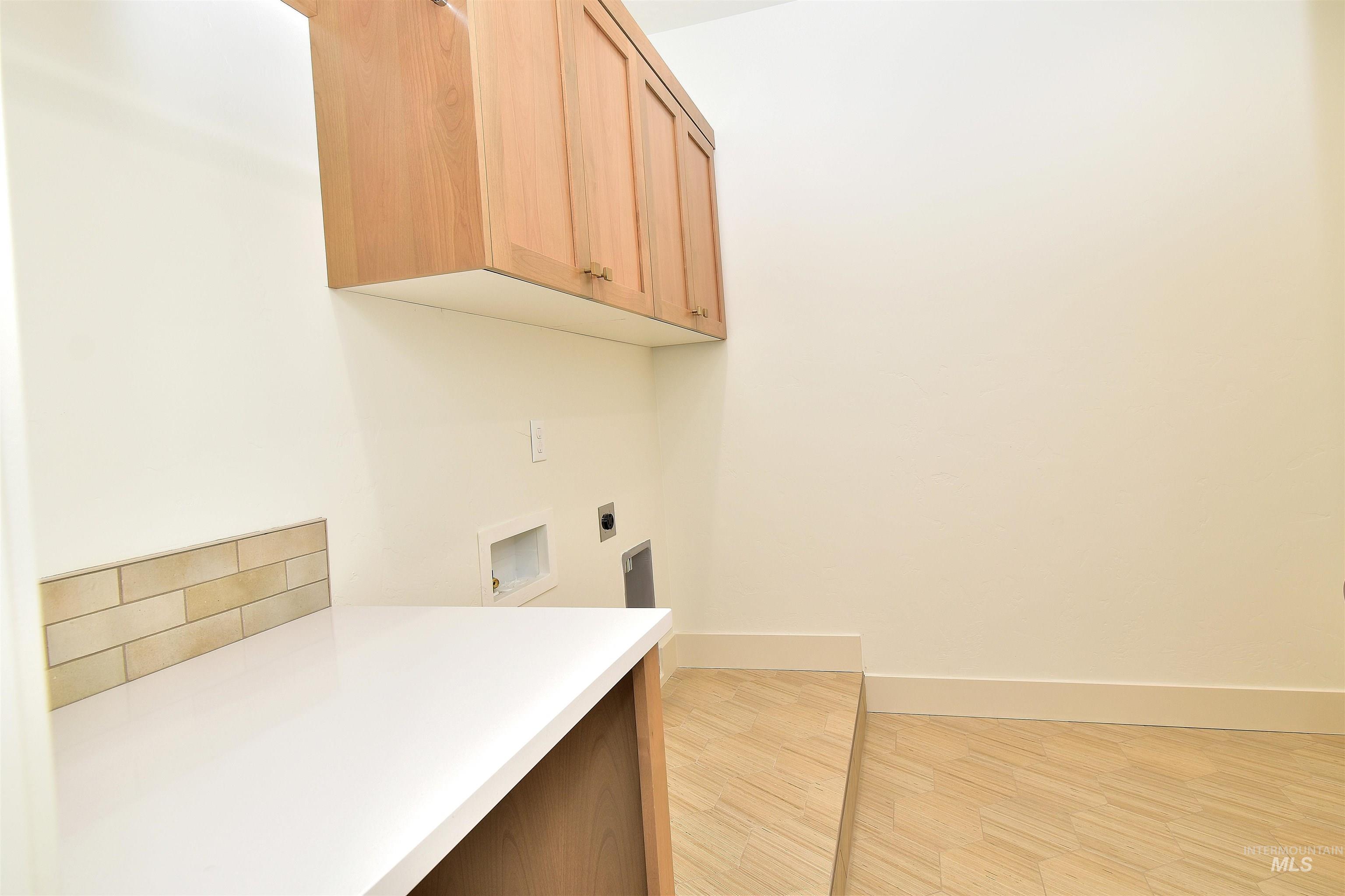 Laundry room featuring light wood-style flooring, electric dryer hookup, and washer hookup