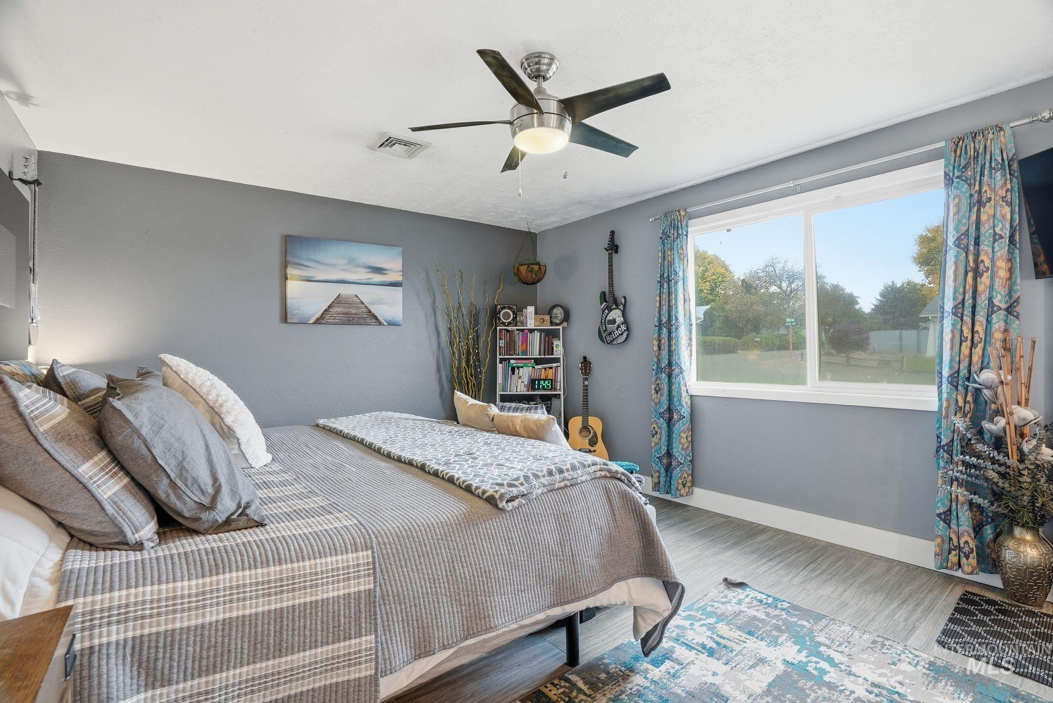 Bedroom featuring wood finished floors and a ceiling fan
