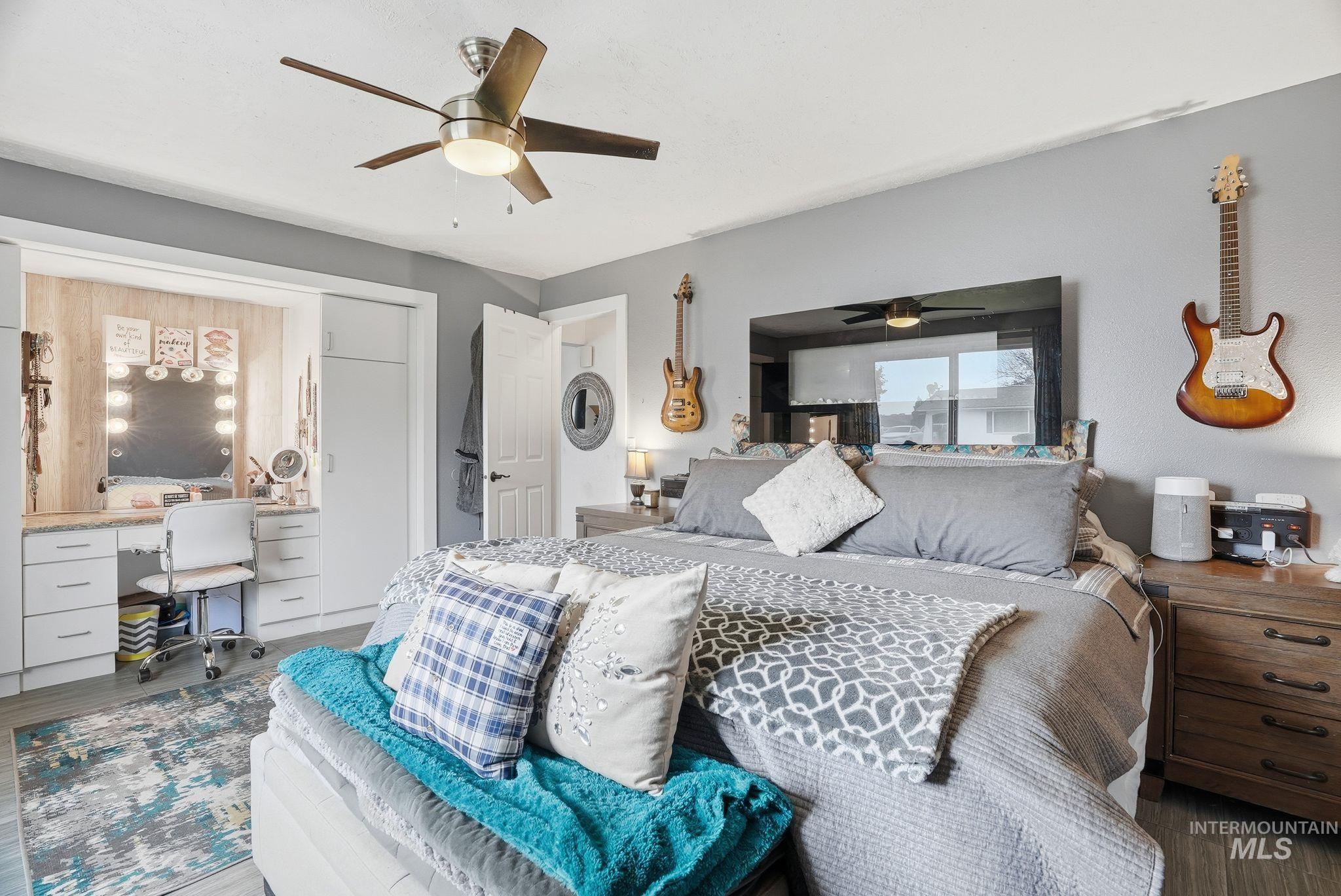 Bedroom featuring wood finished floors, a desk, and ceiling fan