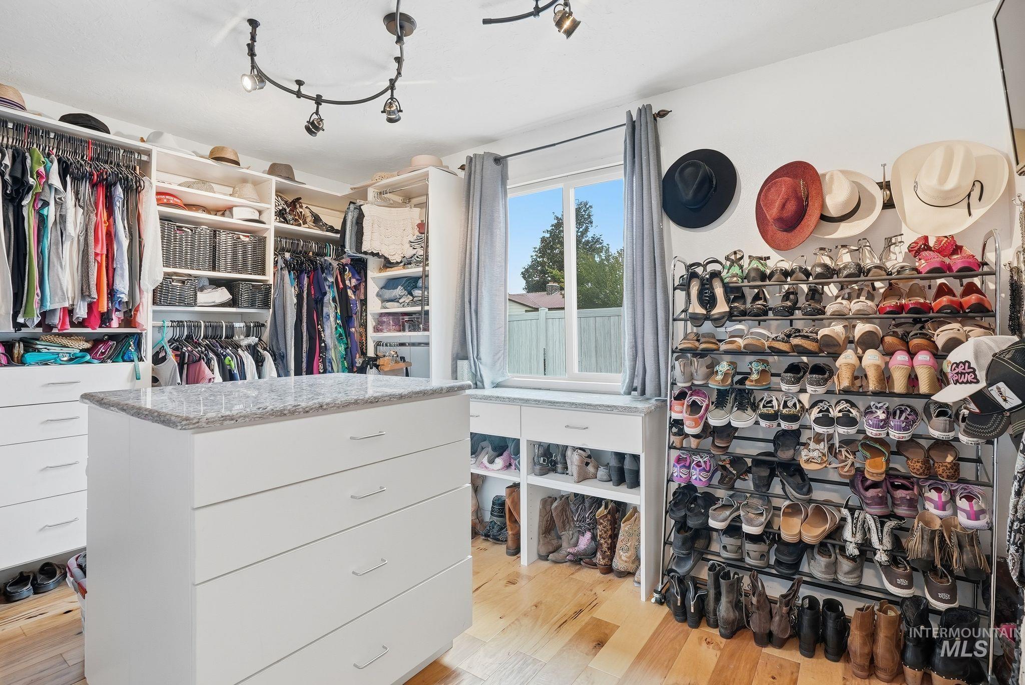 Walk in closet featuring light wood-style flooring
