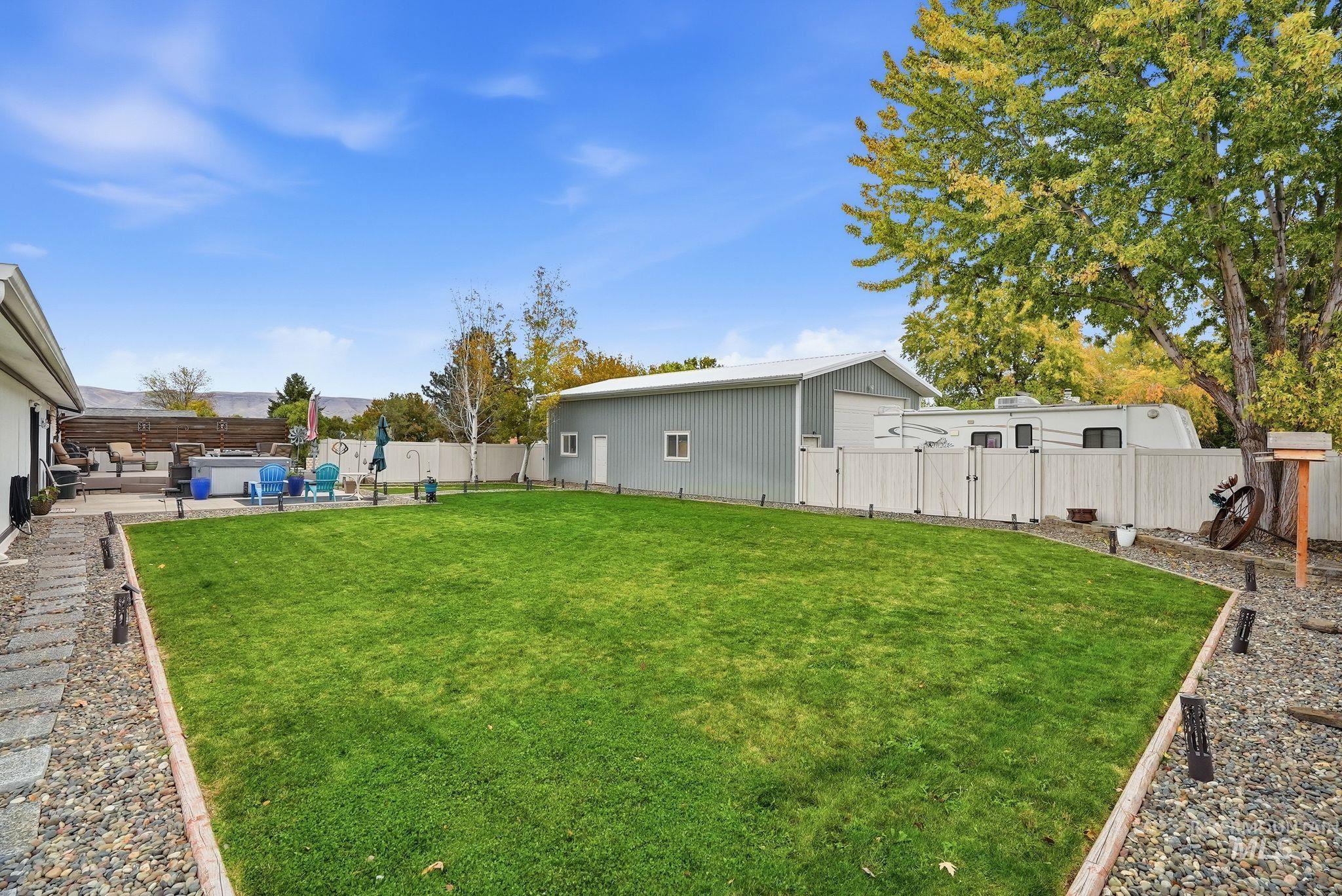 Fenced backyard featuring a patio area and a gate